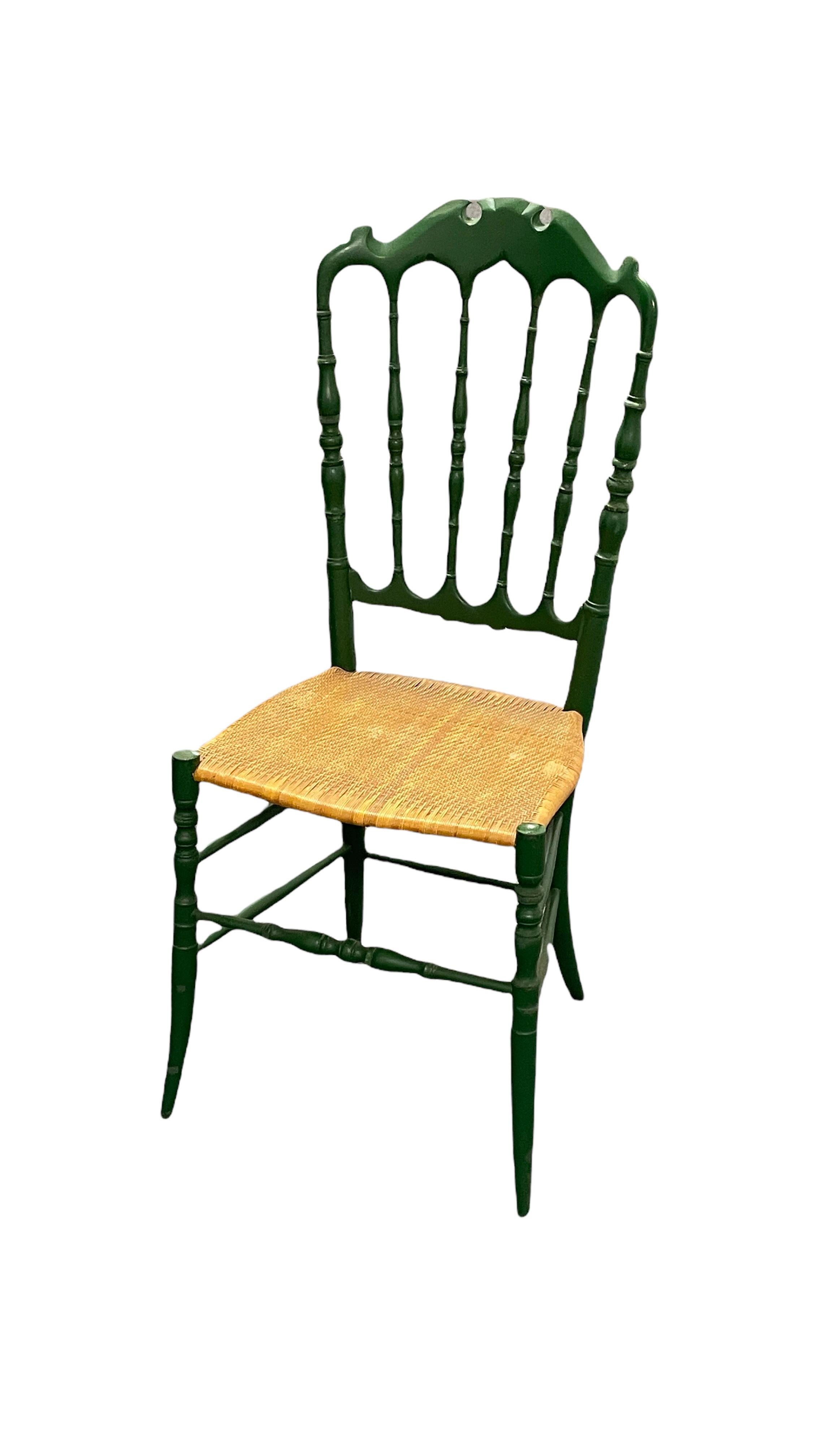 Offered is a beautiful Chiavari chair made by Rocca, Italy, in the 1950s, probably older. It show some minor scratches, also patina and paint lost, but this is old-age. It has a woven wicker seat, minor patina gives this pieces a classy statement.