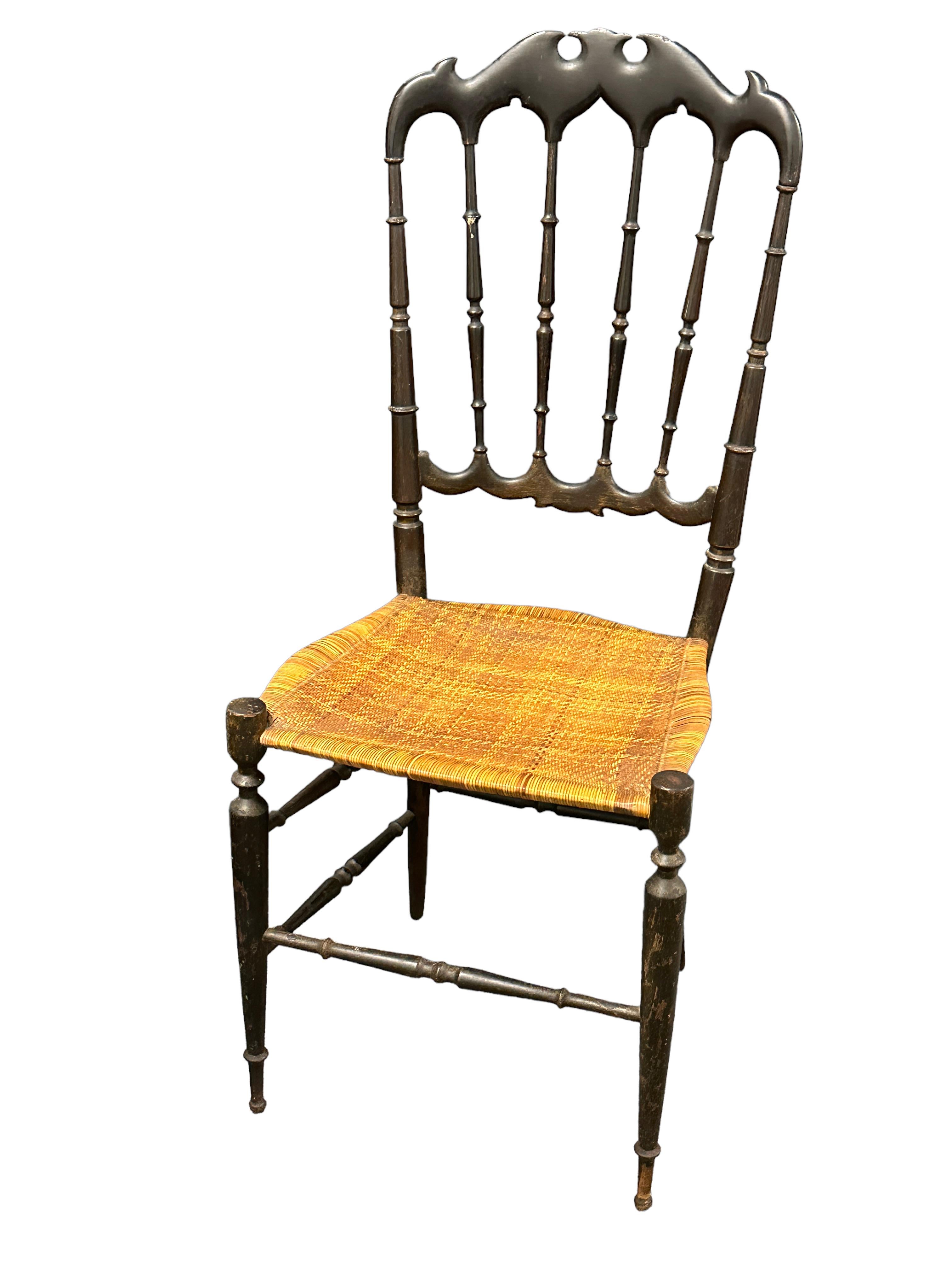 Offered is a beautiful chiavari chair made in Liguria, Italy, in the 1930s, probably older. It shows some scratches, also patina and paint lost, but this is old-age. It has a woven wicker seat, minor patina gives this pieces a classy