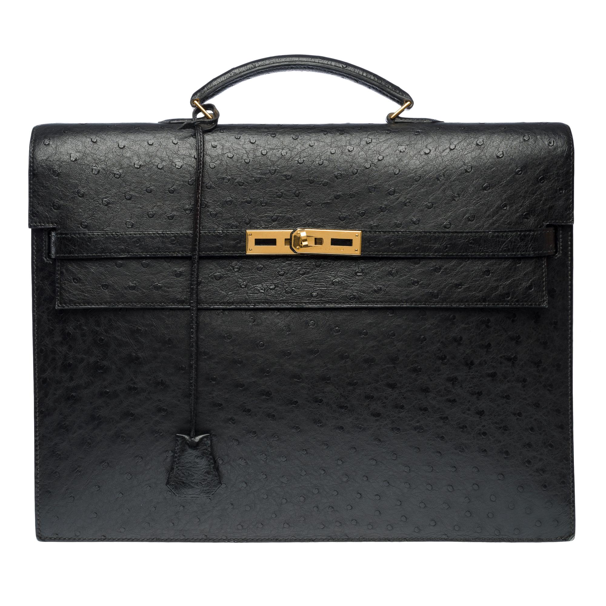 Exceptional​ ​&​ ​Classy​ ​Hermès​ ​Ostrich​ ​Kelly​ ​Dépêches​ ​black​ ​briefcase,​ ​gold​ ​metal​ ​trim,​ ​single​ ​black​ ​leather​ ​handle​ ​allowing​ ​for​ ​hand​ ​carry.

Flap​ ​closure​ ​with​ ​clasp
Interior​ ​in​ ​black​ ​leather,​
