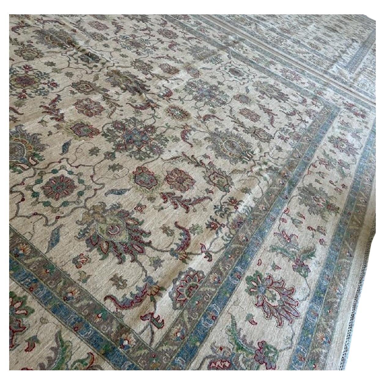 A magnificent large oversized hand knotted Wool Rug. This amazing rug was handmade in Afghanistan. Base colour is of cream/gold. There is a floral pattern throughout. and it has an all over design as opposed to a central medallion feature. There are