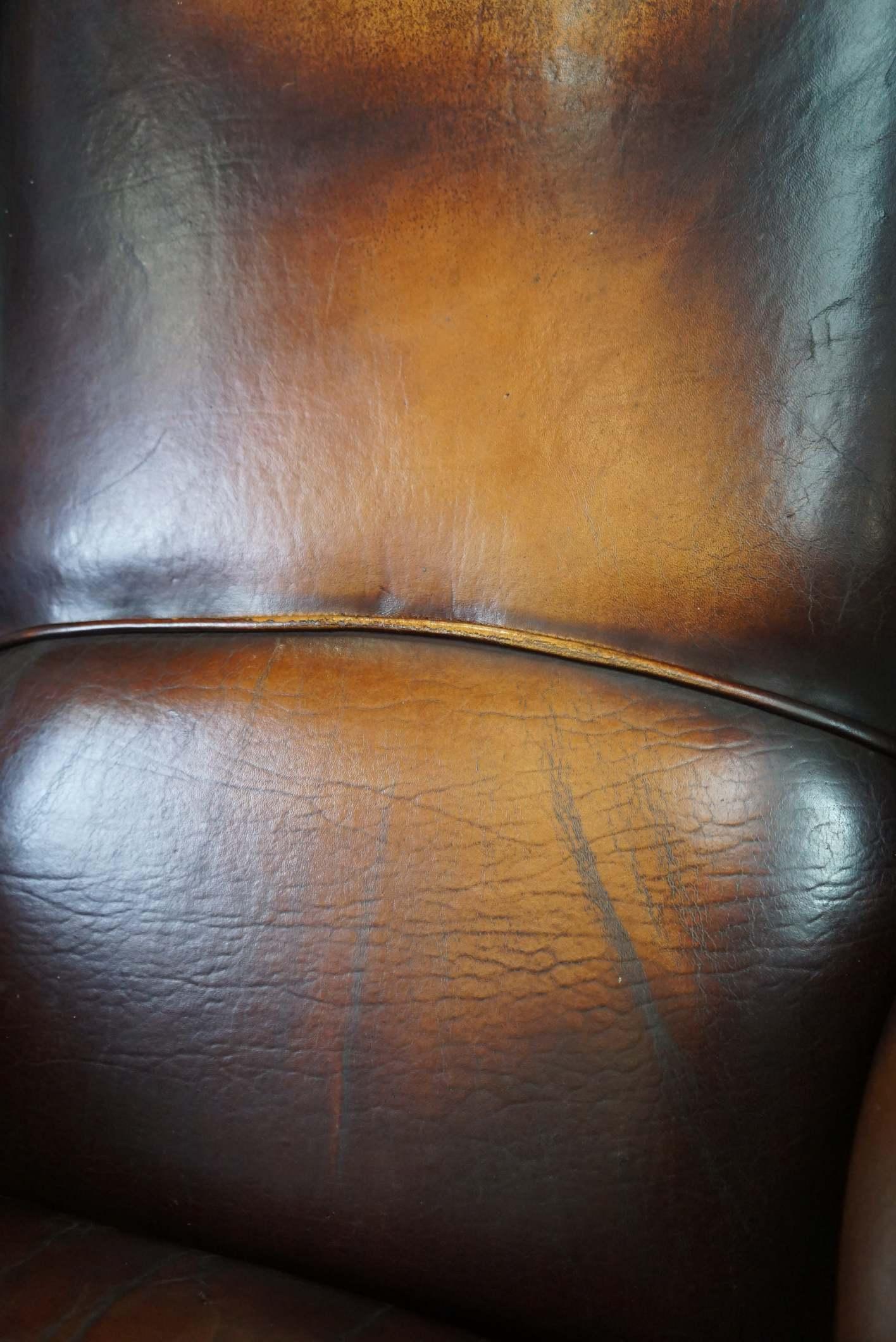 Beautiful classic and stately wingback armchair made of sheep leather with lovel For Sale 3