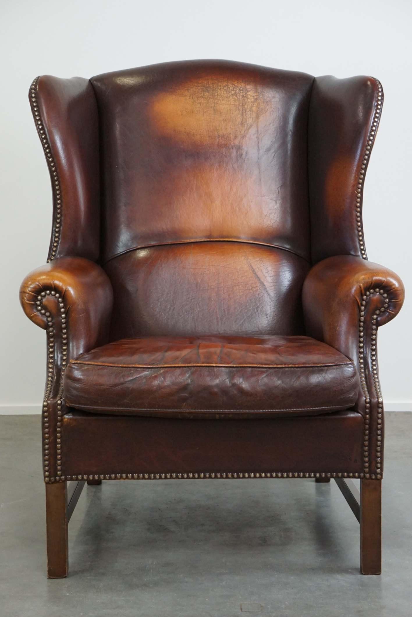 Dutch Beautiful classic and stately wingback armchair made of sheep leather with lovel For Sale