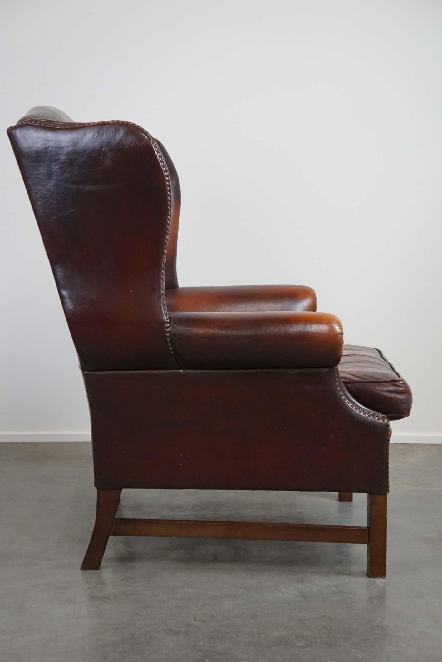 Hand-Crafted Beautiful classic and stately wingback armchair made of sheep leather with lovel For Sale