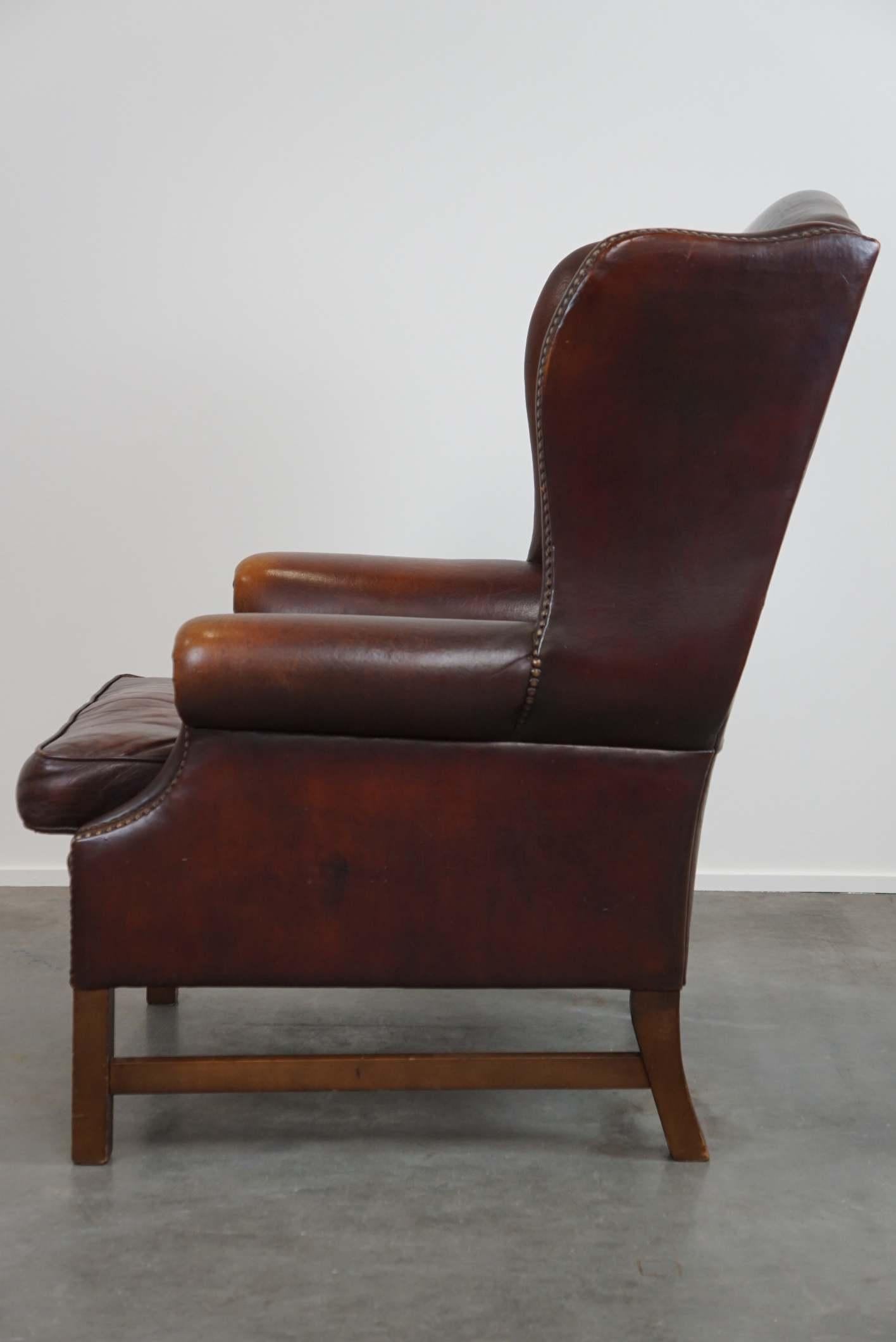 Contemporary Beautiful classic and stately wingback armchair made of sheep leather with lovel For Sale