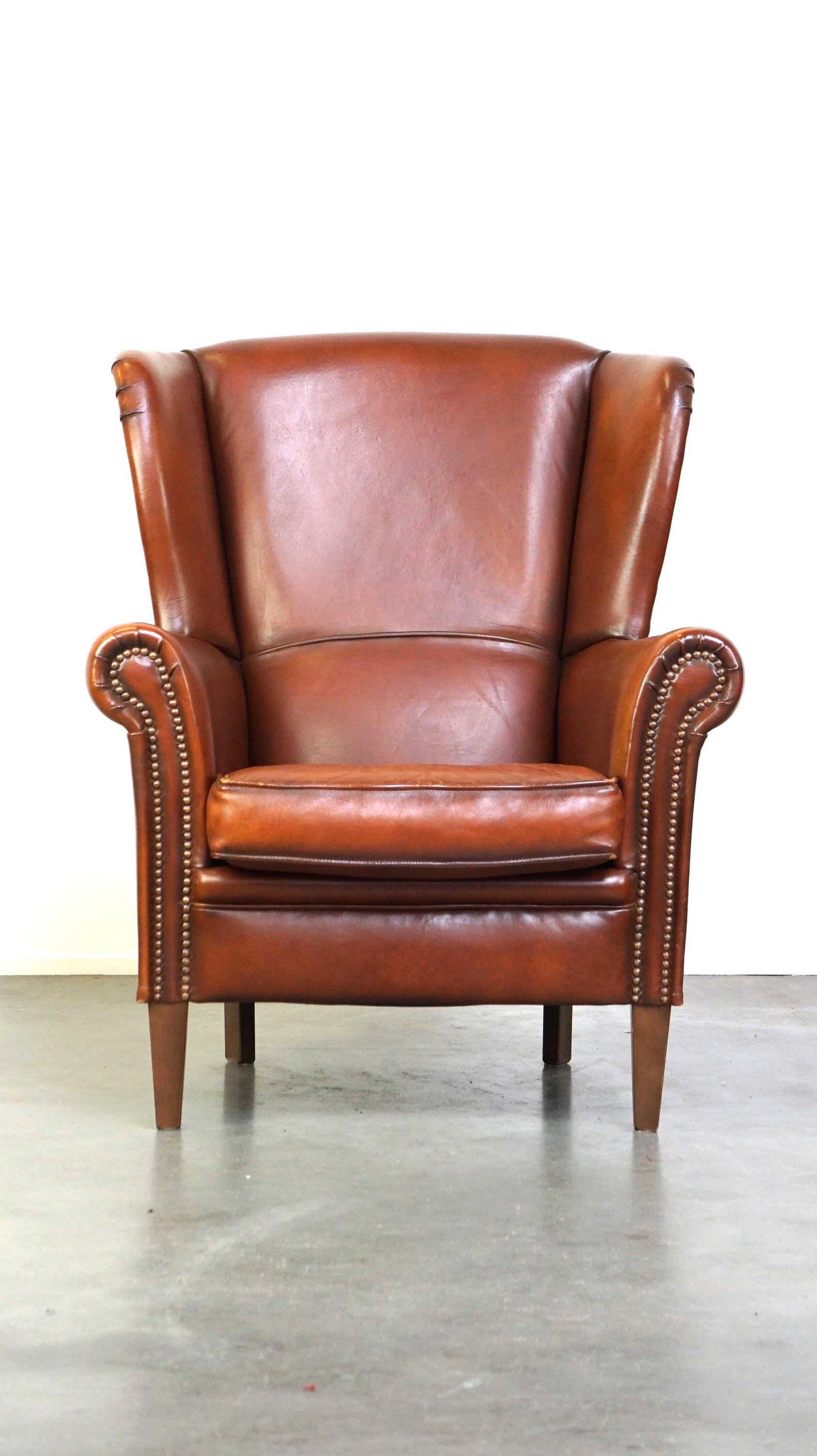 Offered: this beautiful classic sheepskin wingback chair with a stunning appearance and comfortable seating.

Despite—or perhaps because of—its age, this is still a delightful chair for hours of relaxation. This wingback chair is made of sheepskin