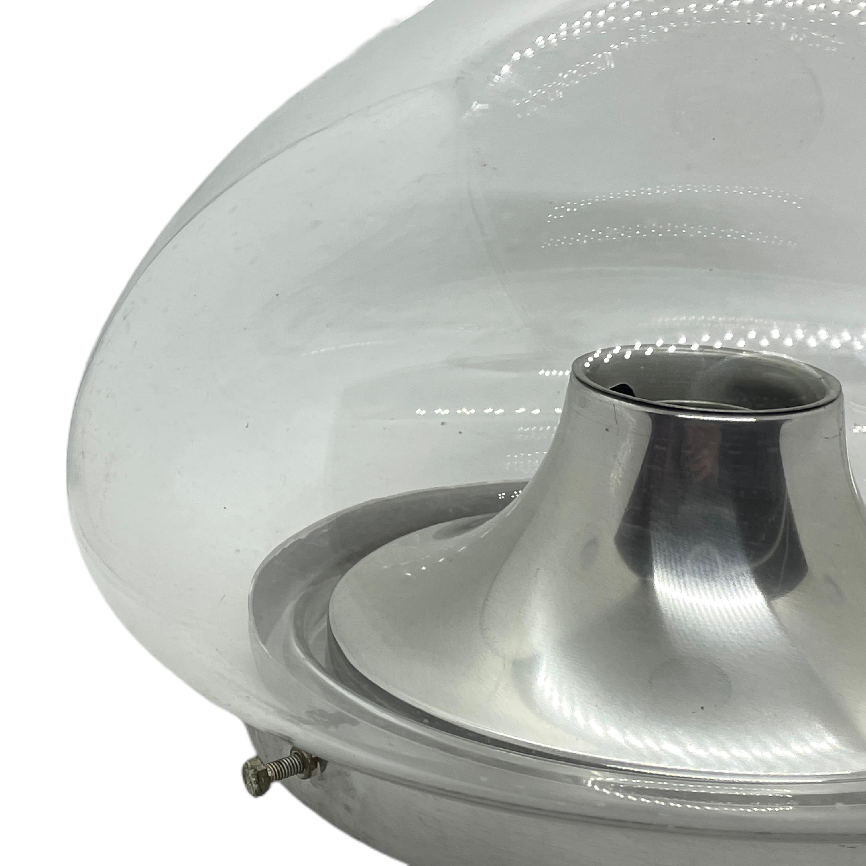 A beautiful flush mount by German manufacturer Doria Leuchten. The glass element is supported by a aluminum base plate with a one light source. Beautiful clear glass on a metal fixture. The Fixture requires one European E27 / 110 Volt Edison bulb,
