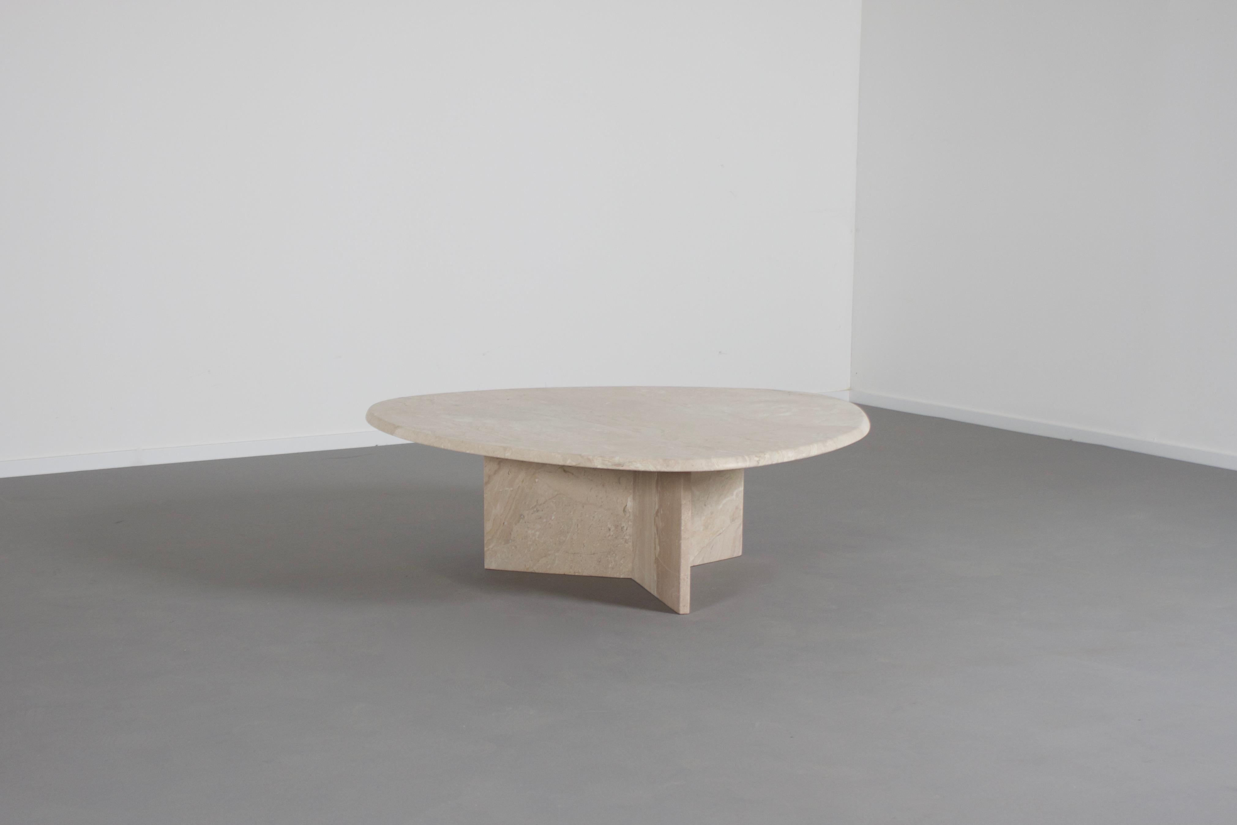 Beautiful coffee table in excellent condition.

The table has a organic triangular shaped top made of natural silky travertine.

The base is formed of three slabs of travertine which combine into a star shape.

The travertine surface is absolutely