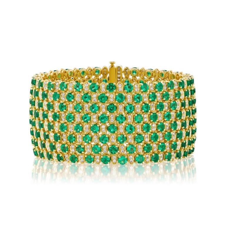 BEAUTIFUL COLOMBIAN EMERALD AND DIAMOND BRACELET An elegant diamond and Emerald trellis winds its way around the wrist. Its a handmade piece made with perfectly matched Colombian Emerald rounds and diamonds Item: # 03687 Metal: 18k Y Color Weight: