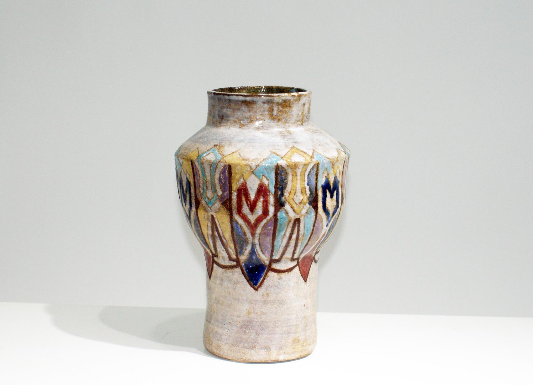 French Art Deco vase signed “Vallauris” on the reverse.
Made of pottery with pastel light beige and decorated by geometric colorful motifs.
 