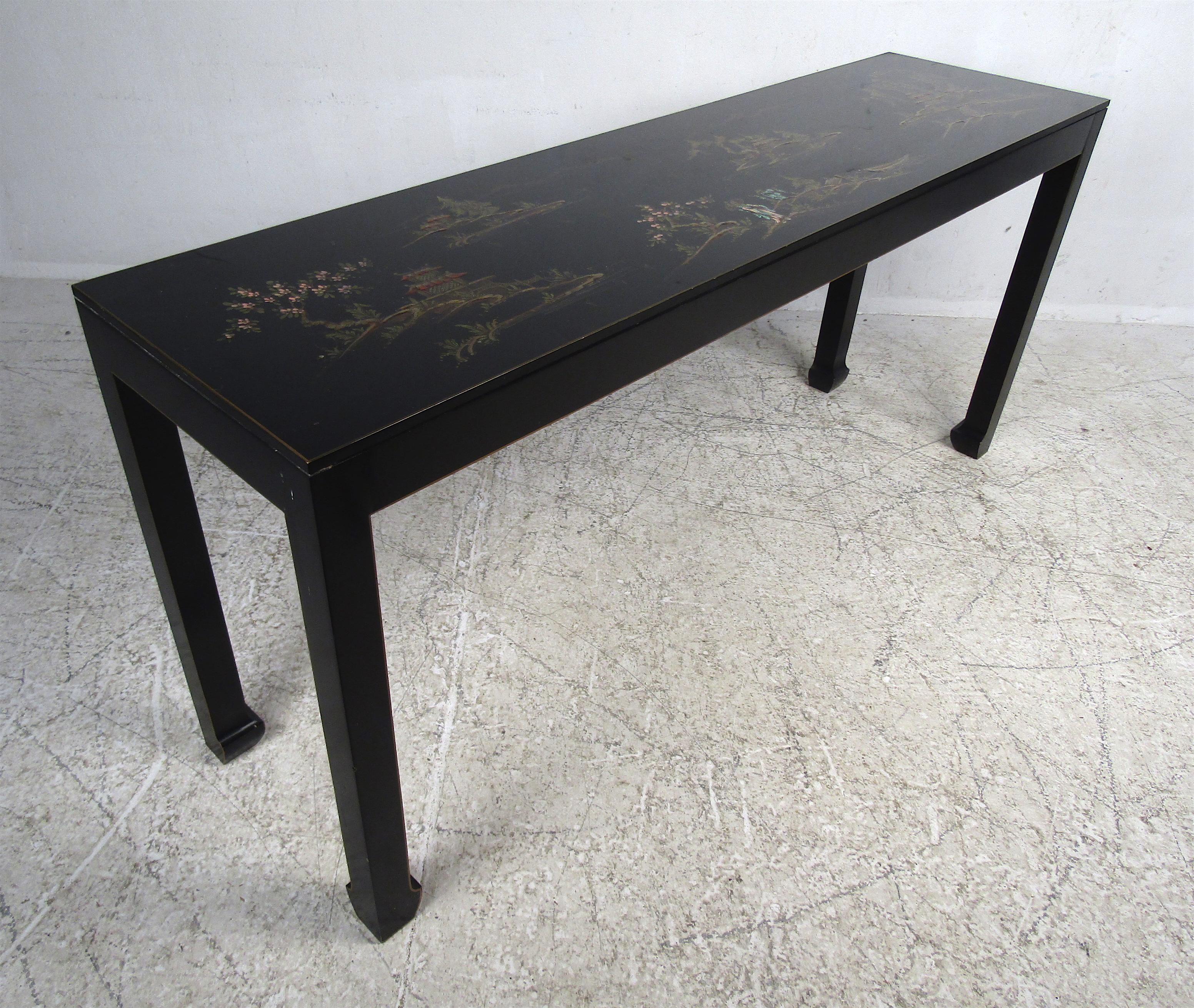 This stunning black lacquered console table boasts decorative Asian designs on the top. Four sturdy legs with sculpted feet add to the allure. This works great in any hallway, entryway, or behind any sofa. Please confirm item location (NY or NJ).