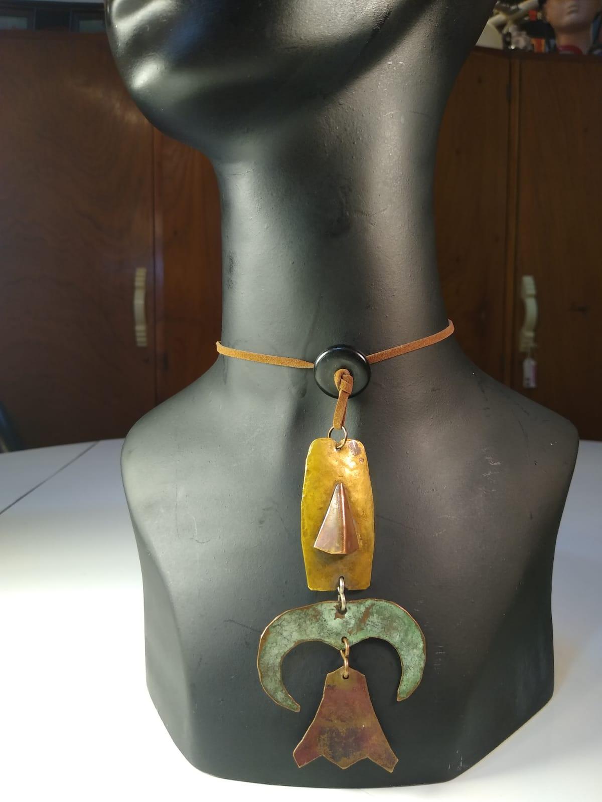 Beautiful necklace handmade by Ken Beldin in Mexico around the 1950s. Simple, whimsical design made with simple materials: hammered copper and brass attached with two simple S-shaped wires, incorporated into a long, brown leather cord with one round