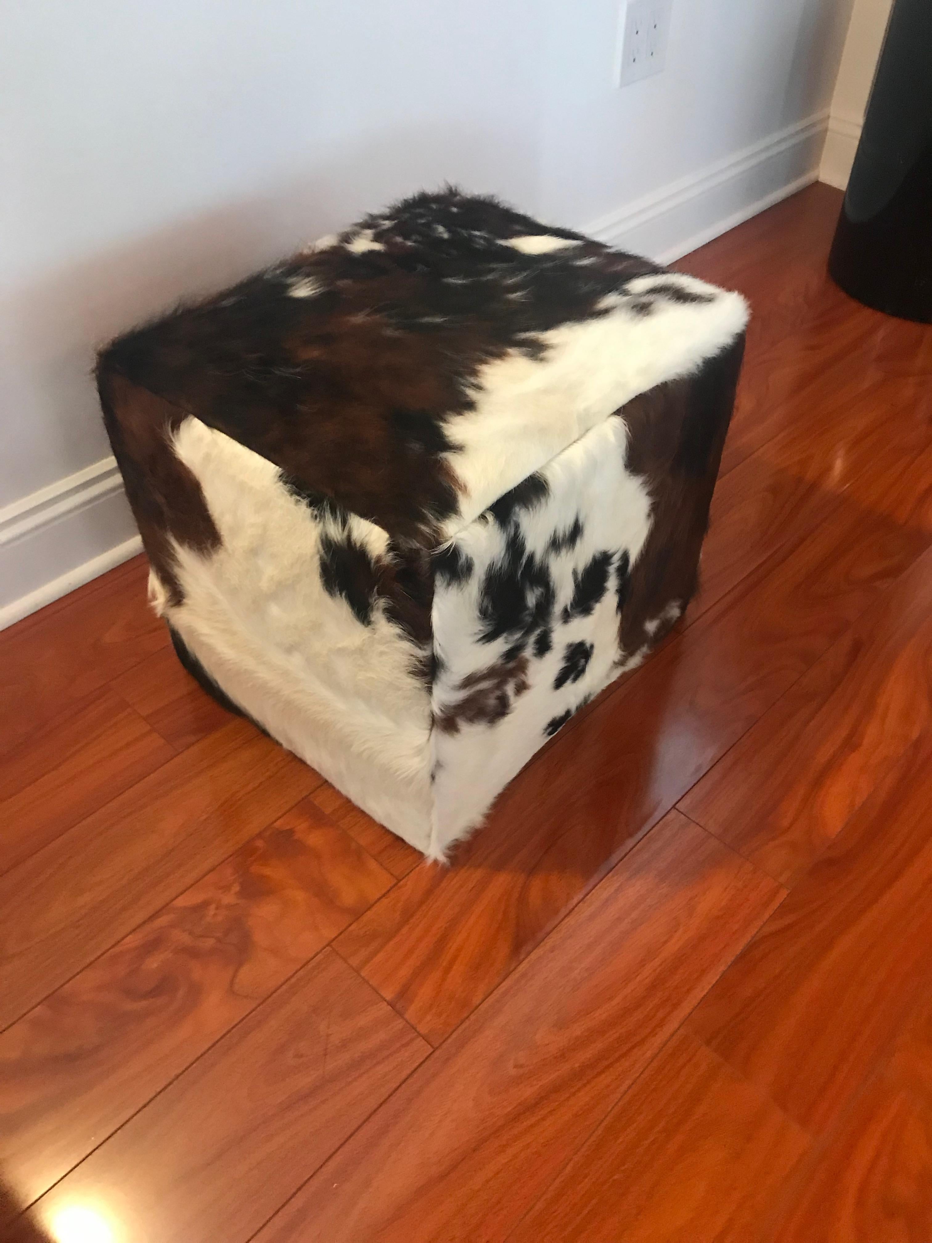 Modern upholstered ottoman or bench with cow hide. this ottoman has been re upholstered in cowhide. Perfect for any decor adding that extra touch.