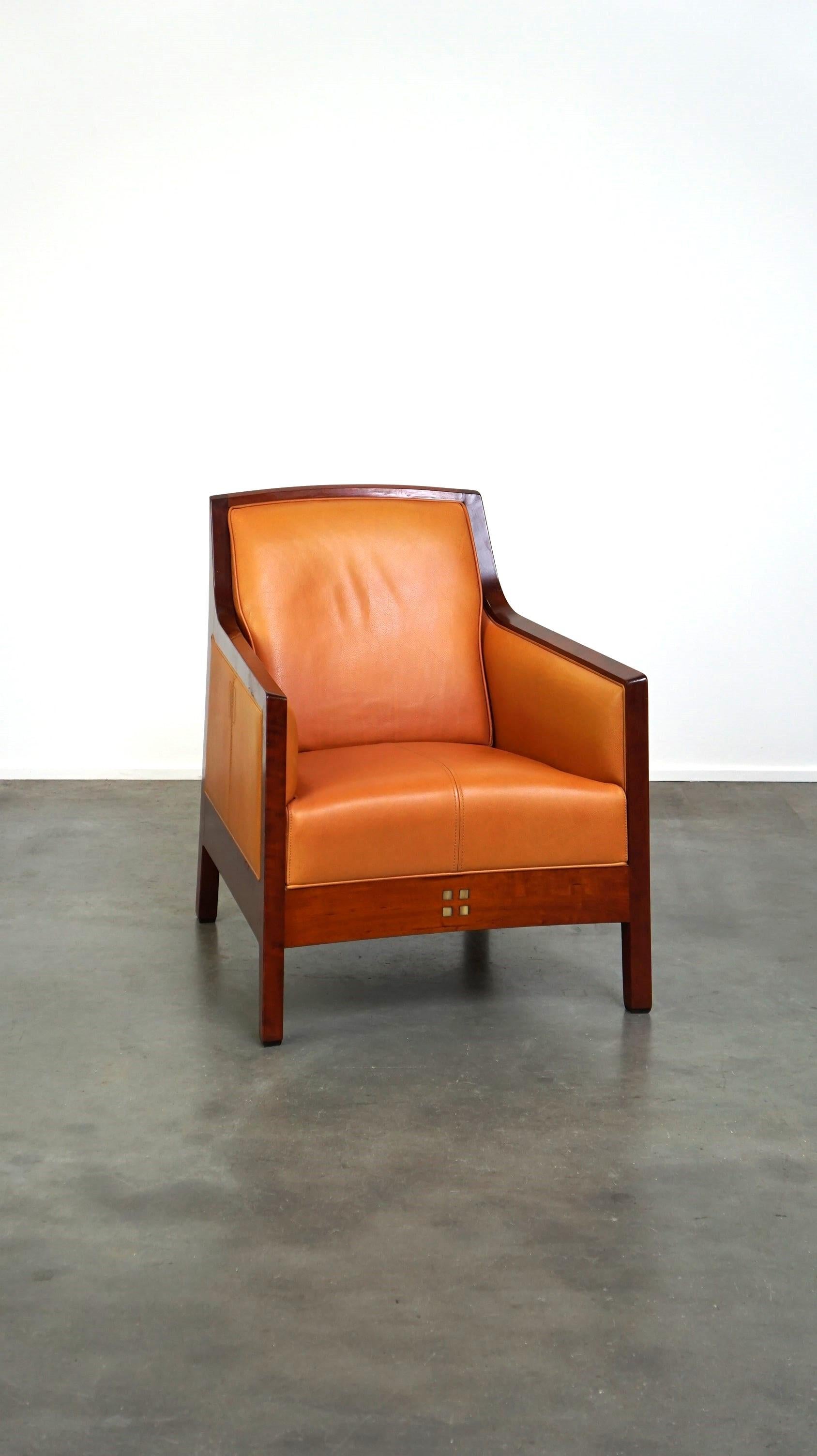 Offered this beautiful cowhide Artdeco design armchair. High comfort and unique details.

What a unique and beautiful appearance this is! This beautiful design armchair is in a very good and correct condition and also sits great. It is equipped with