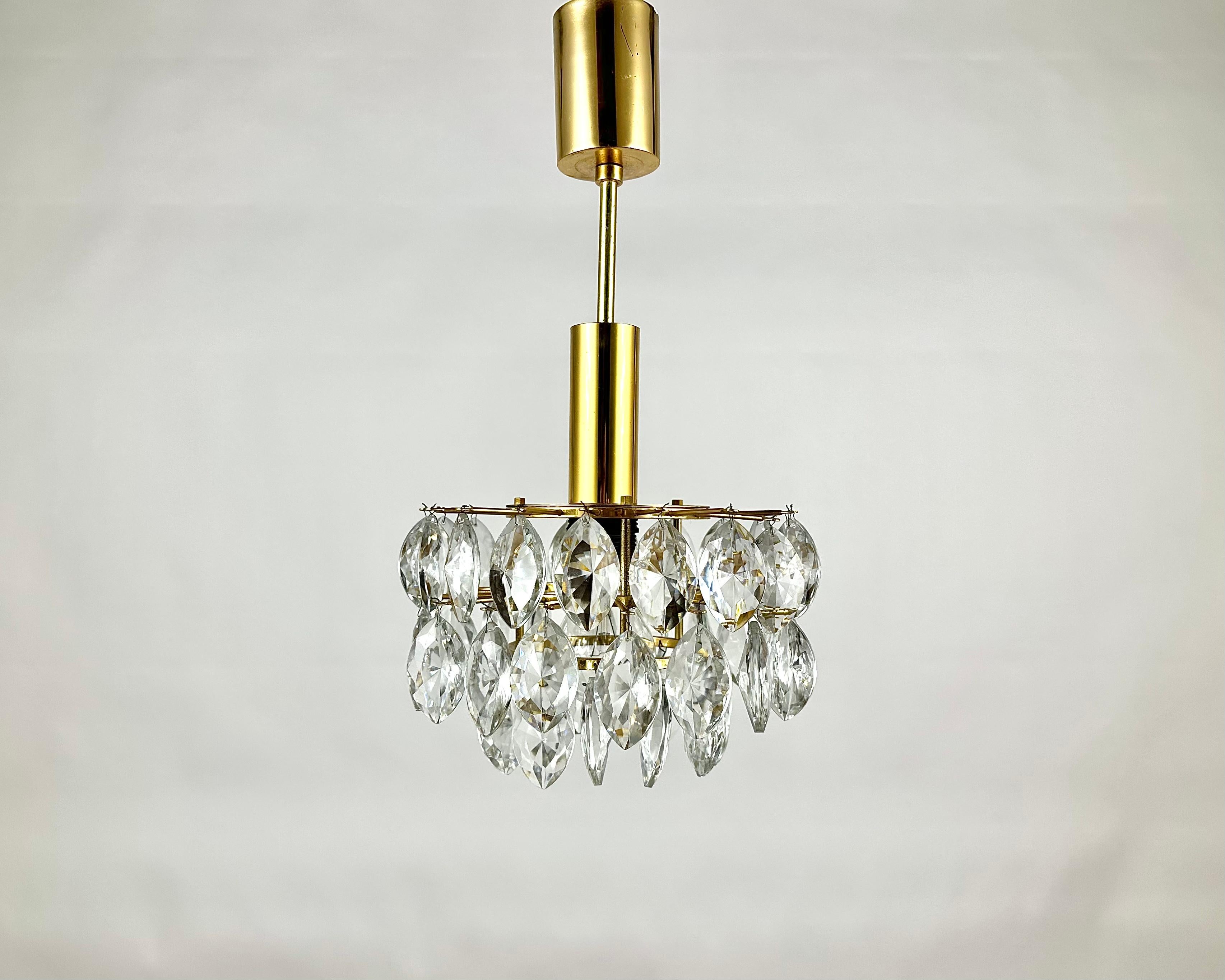Vintage Crystal and Brass Chandelier for 1 light point.

Manufactured in Germany.

This beautiful chandelier has a classic style and is made of high quality materials that guarantee durability and reliability. 

One of the main advantages of this