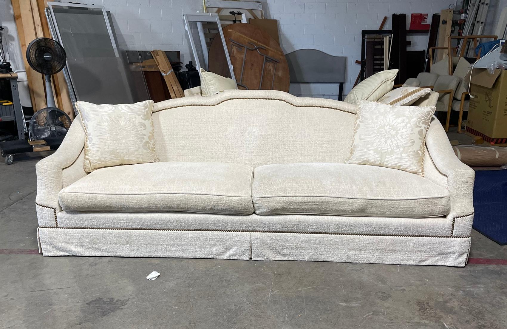 Beautiful custom made sofa upholstered in a cream fabric, solidly built and very comfortable.

The sofa can easily seat 4 people, the curved arms look stunning and the metal studs really stand out.

Measurements:

109 inches wide 39 inches