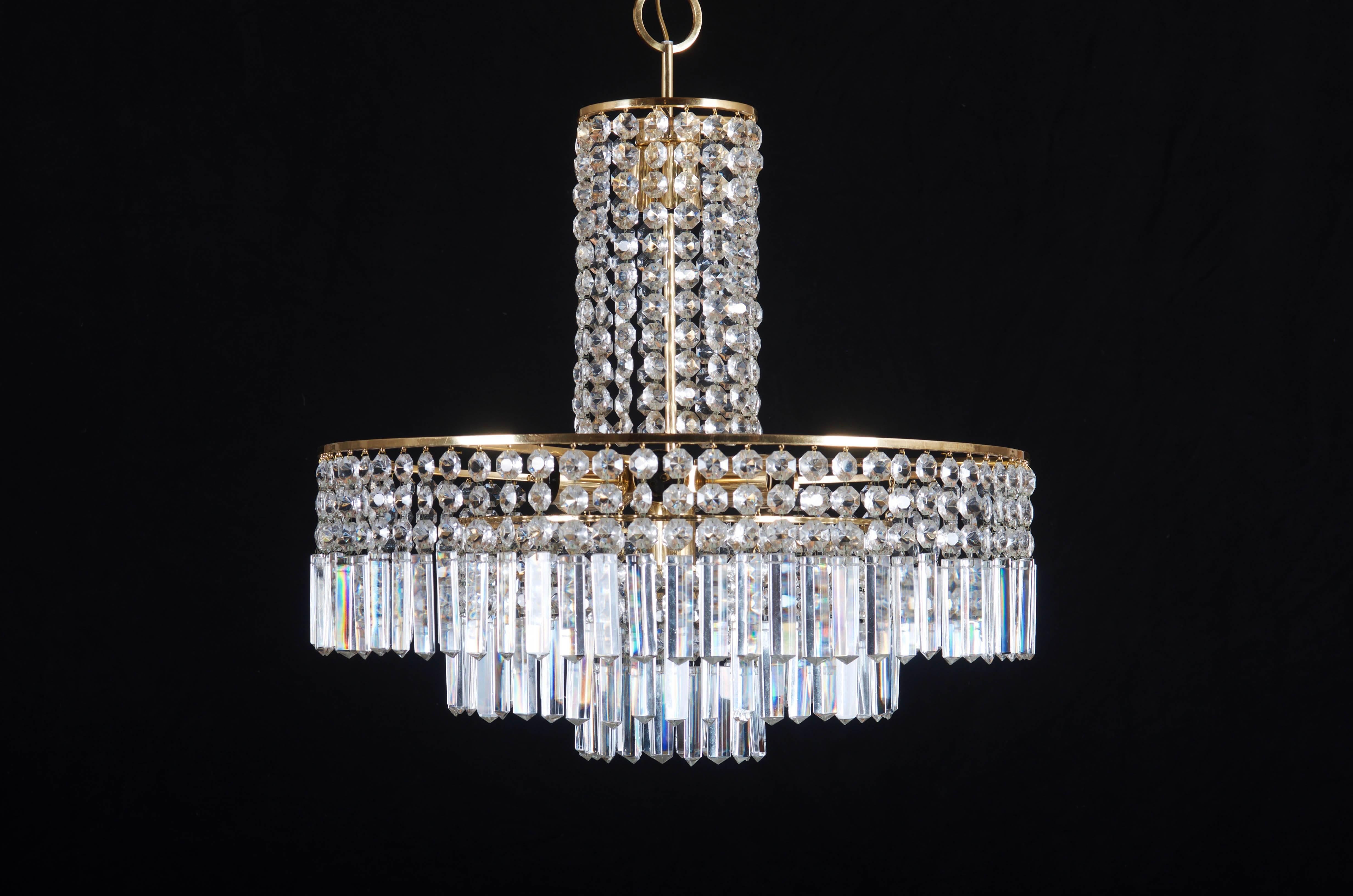 Three layers brass construction with cut crystal elements fitted with seven E27 and three E14 sockets up to 60 watts each.
Made in Vienna in the 1960s by Bakalowits & Sohne.
The dimension of the chandelier only is,
diameter 56 cm (22
