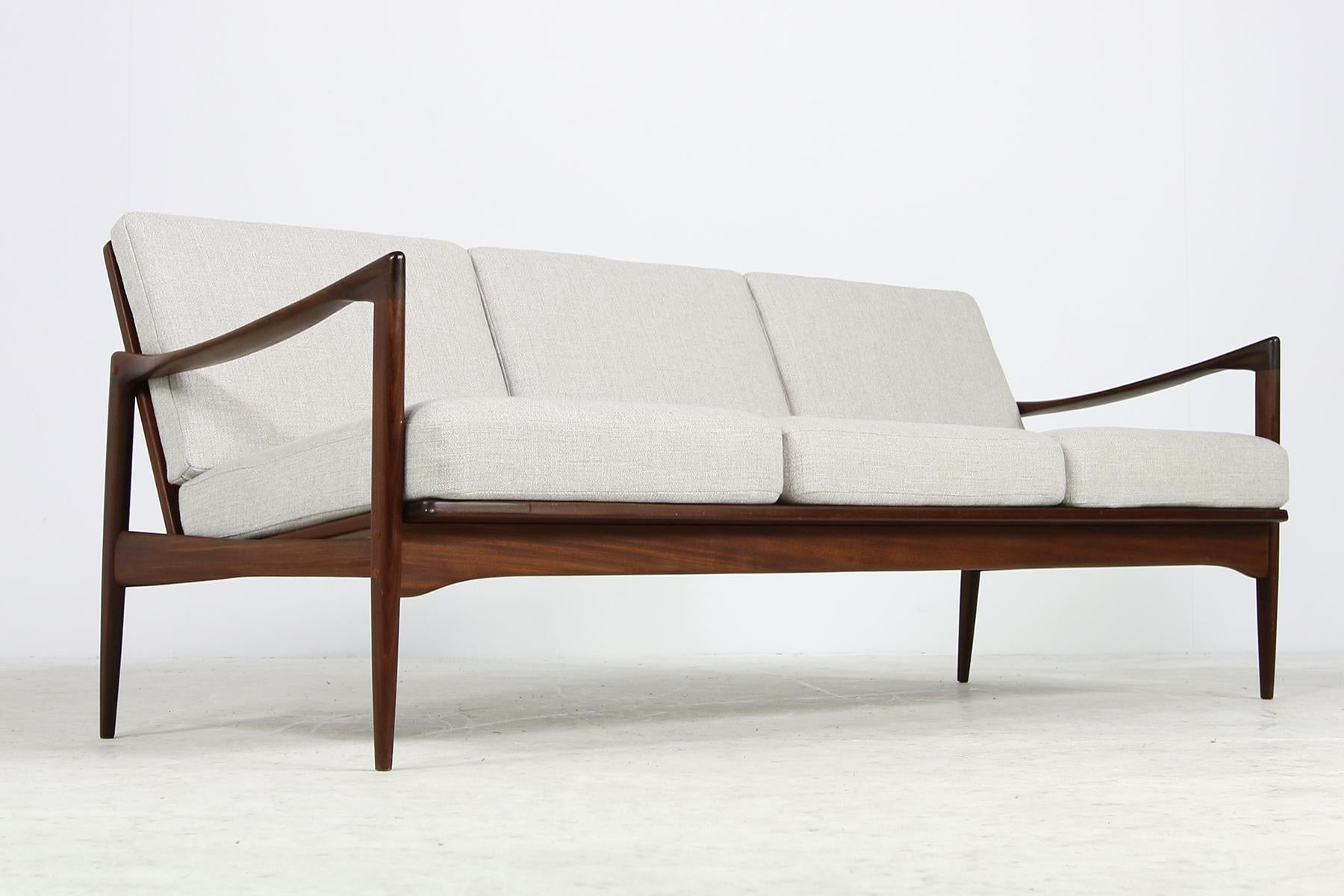 Beautiful, rare 1960s Danish modern teak sofa, designed by Ib Kofod Larsen, Model 'Kandidaten' in a fantastic authentic condition, the dark, solid teak wood is in a fantastic condition, perfect Minimalist shape, the cushions were upholstered and
