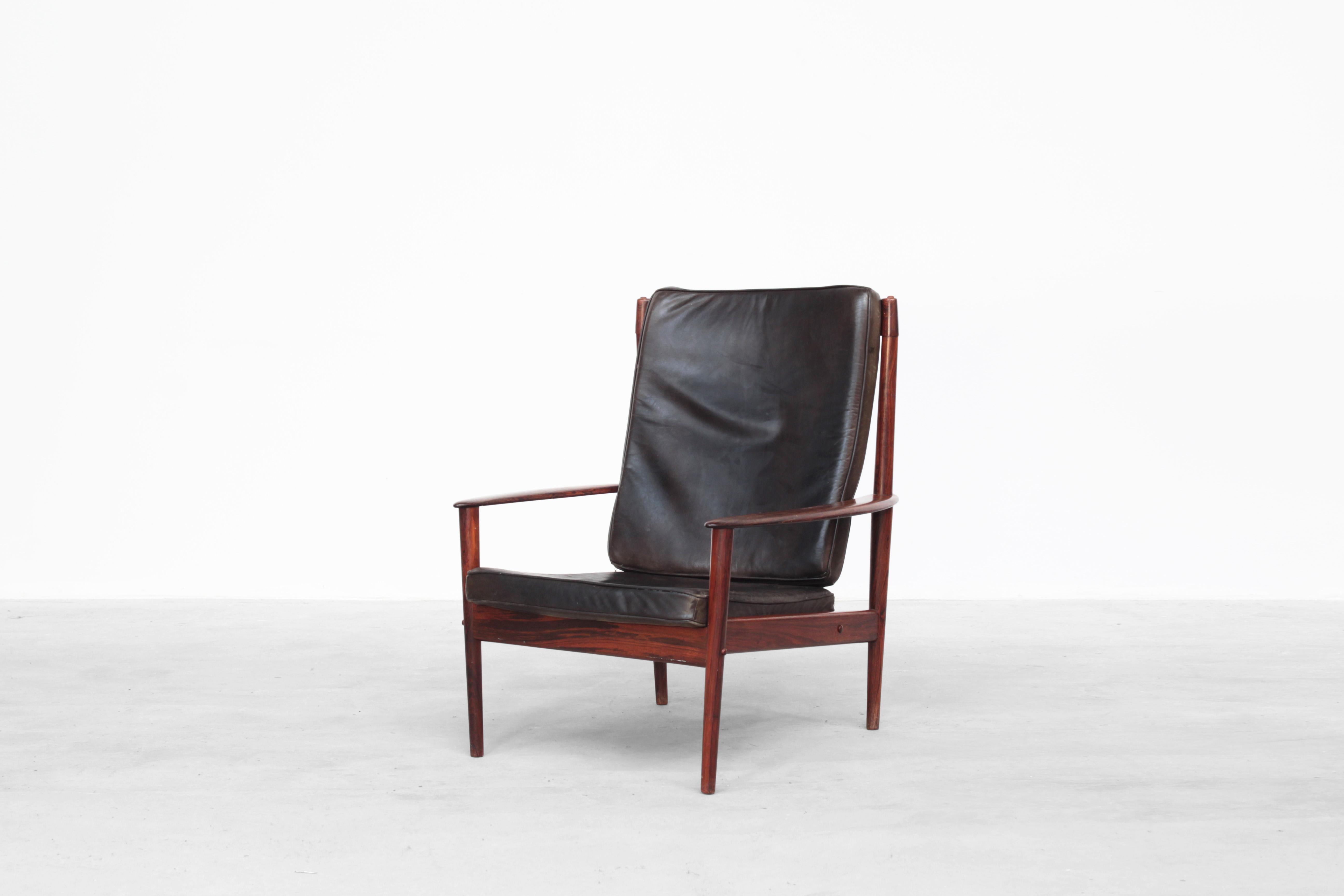 A beautiful easy chair designed by Grete Jalk and produced by P. Jeppesen in the 1960s. The chair is in great condition with just little traces of usage. The cushions are covered with brown patinated leather. The frame is made out of dark wood and a