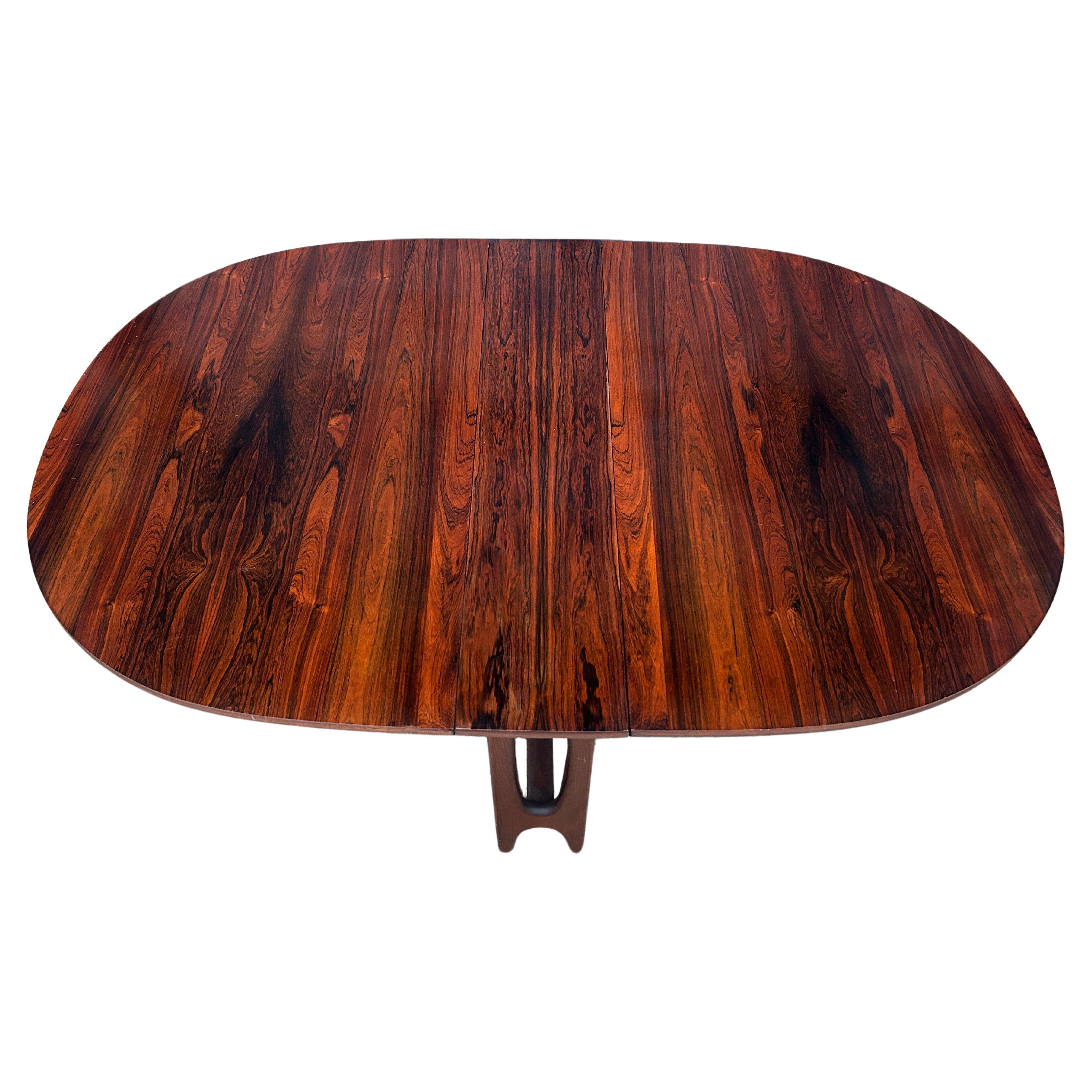 Scandinavian Modern Rosewood oval Drop Leaf folding dining Table made in Norway. Very clean table with 2 fold down leaves - Amazing wood grain. ready for use. Seats 4-6 chairs Located in Brooklyn NYC.

Table folded is 40” wide x 8” deep x 29” tall