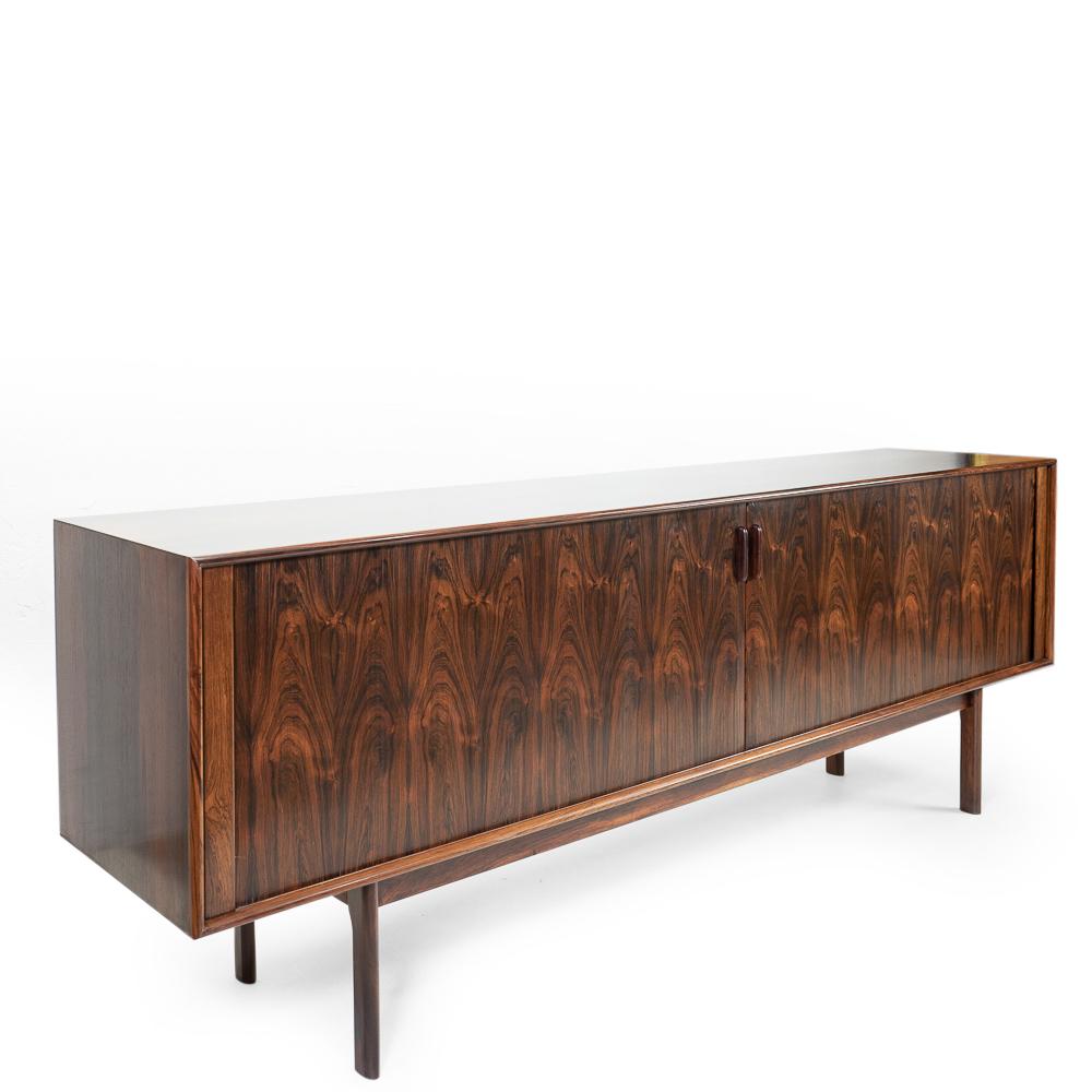 Sideboard with tambour doors in exotic hardwood by Henning Kjaernulf for Bruno Hansen.

Beautiful book-matched sliding doors.

Note that the back has also been veneered, therefore this piece could also work as a room-divider.

 
 

Condition: Good