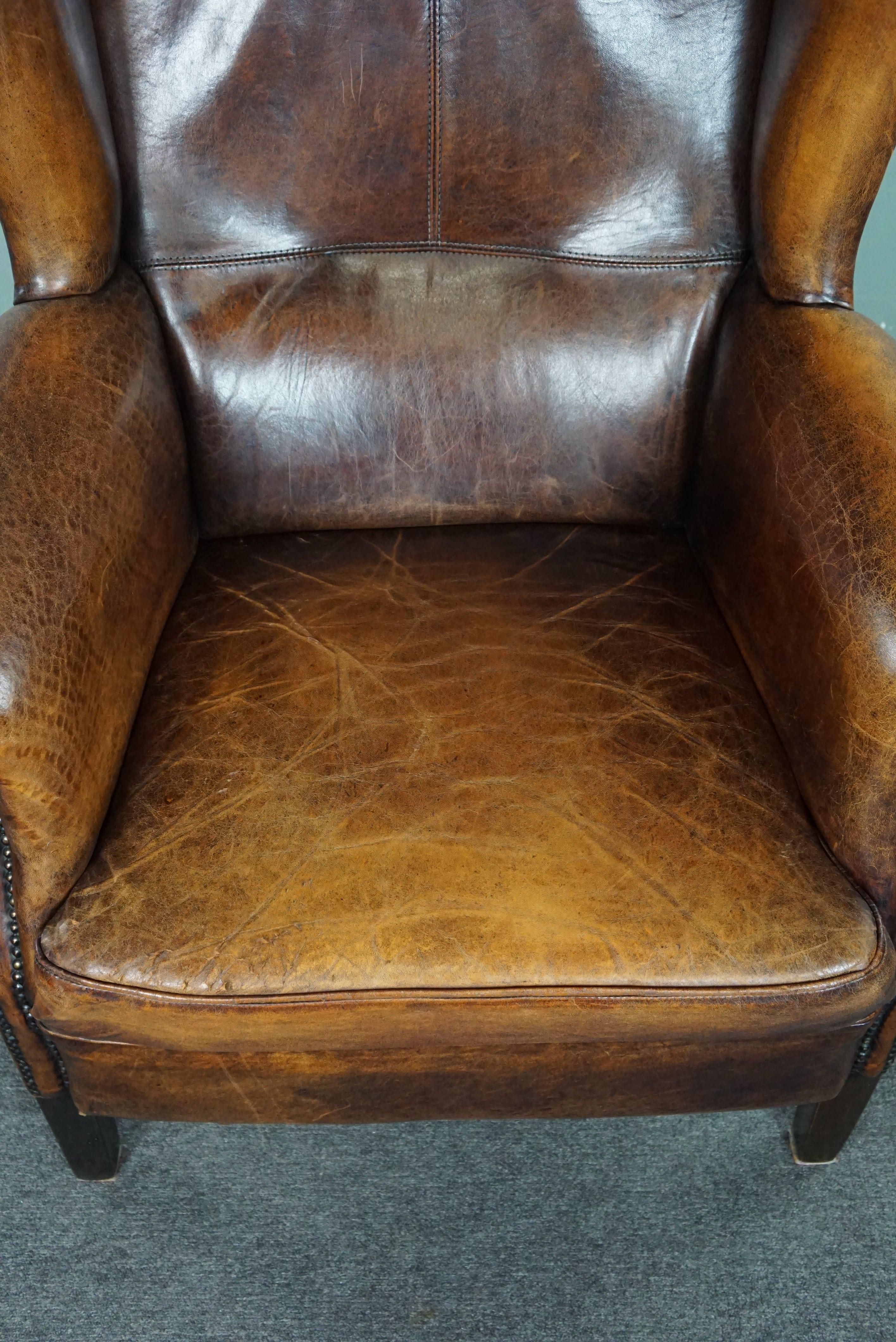 Leather Beautiful dark wing chair made of sheep leather with beautiful colors For Sale