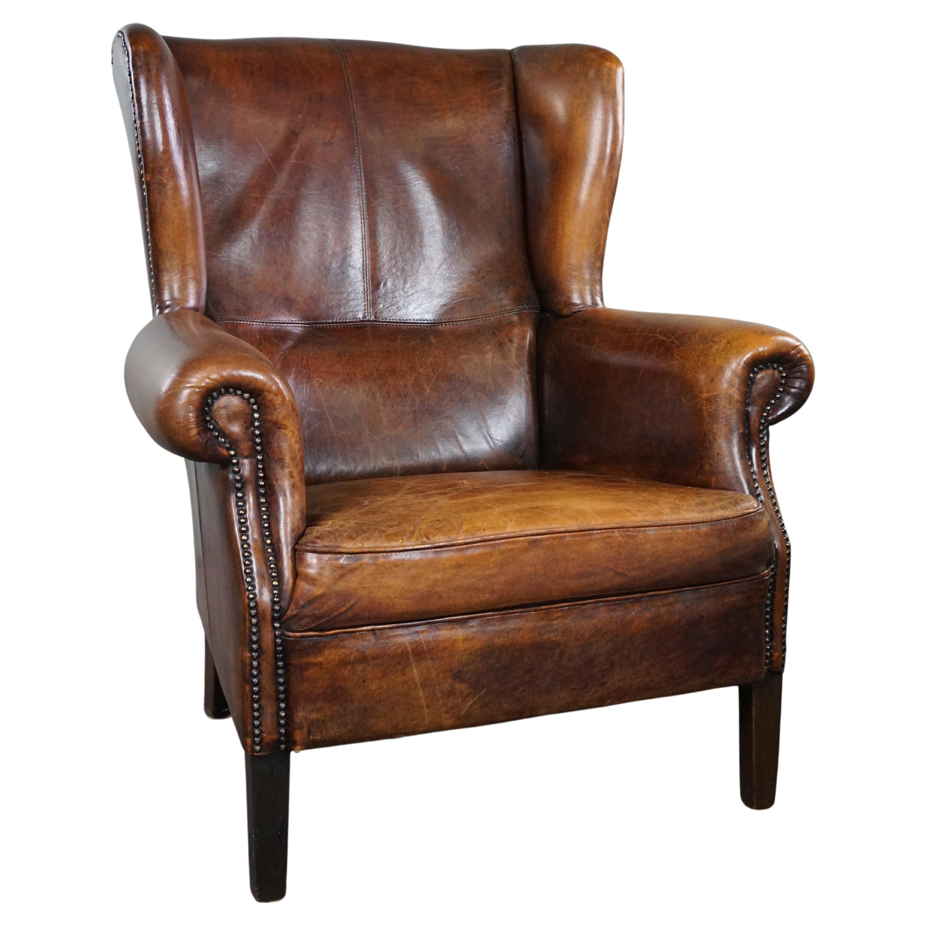 Beautiful dark wing chair made of sheep leather with beautiful colors For Sale