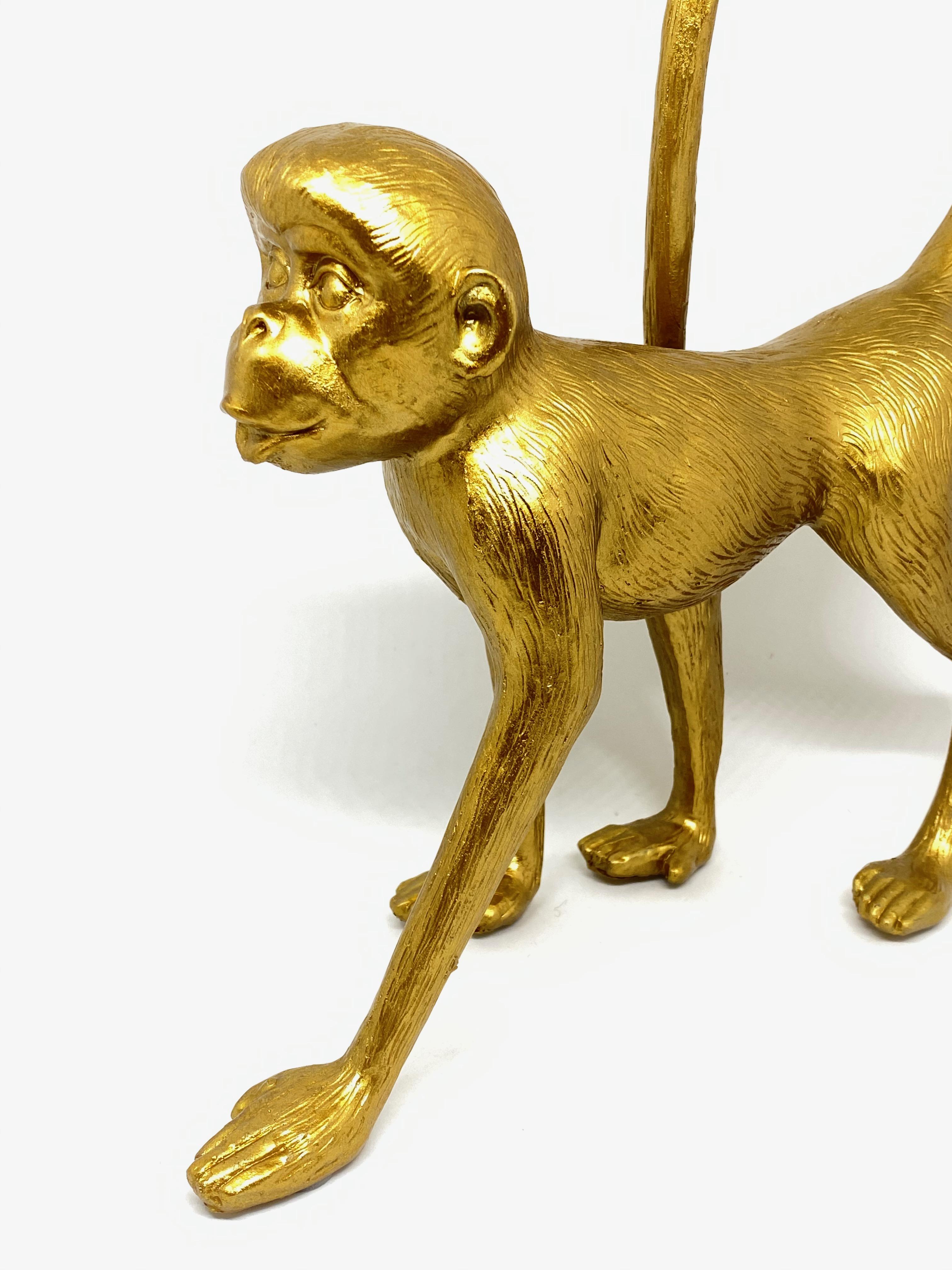 Vintage beautiful monkey animal statue. It is highly decorative, made of resin and gilt hand painted body. A nice addition to the Hollywood Regency interior.