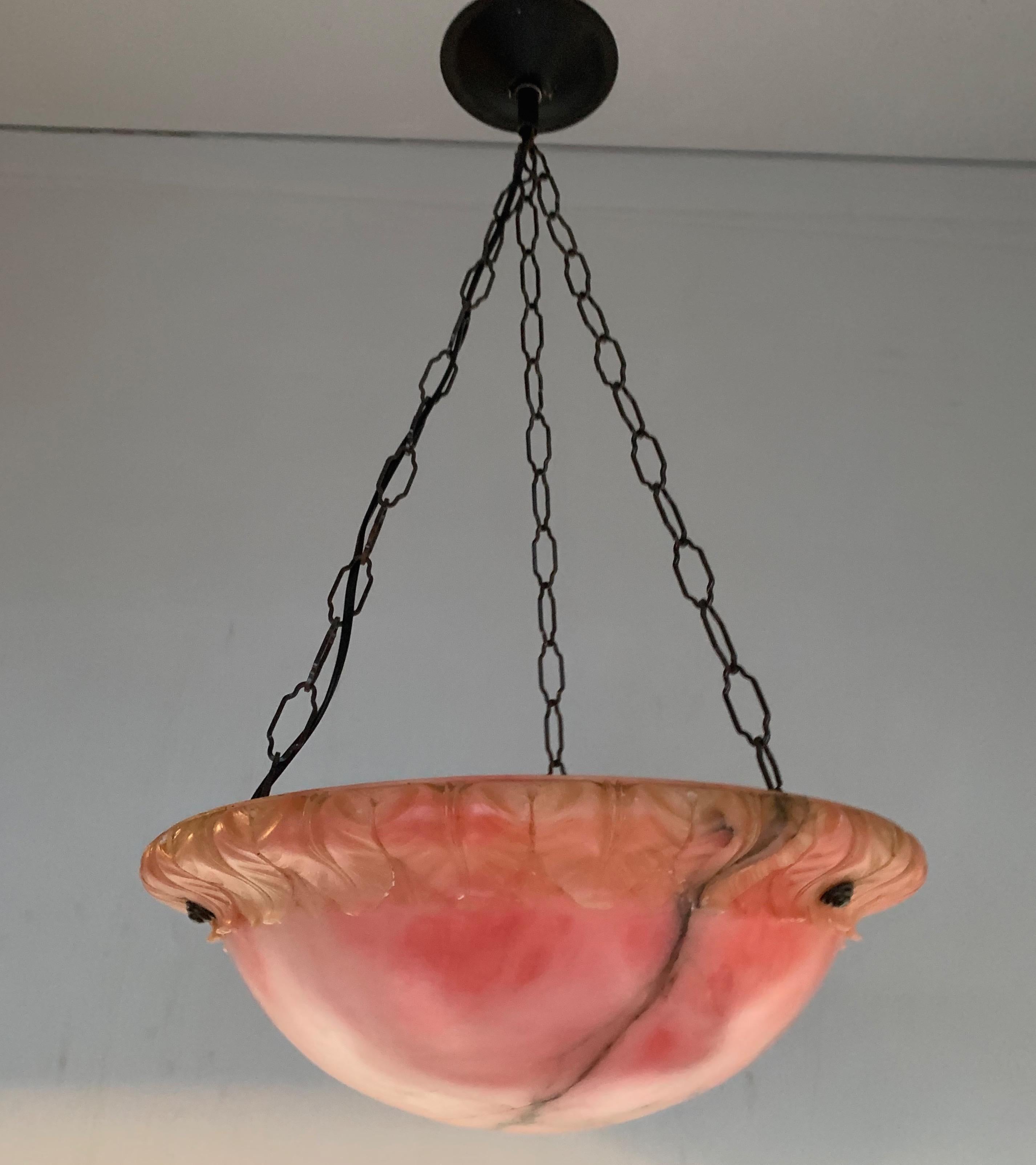 Good size and top quality carved alabaster pendant with black color chain and canopy.

This early 20th century handcrafted pendant comes with a perfect condition alabaster shade. The stylish edge with curved leaf design makes this pendant extra