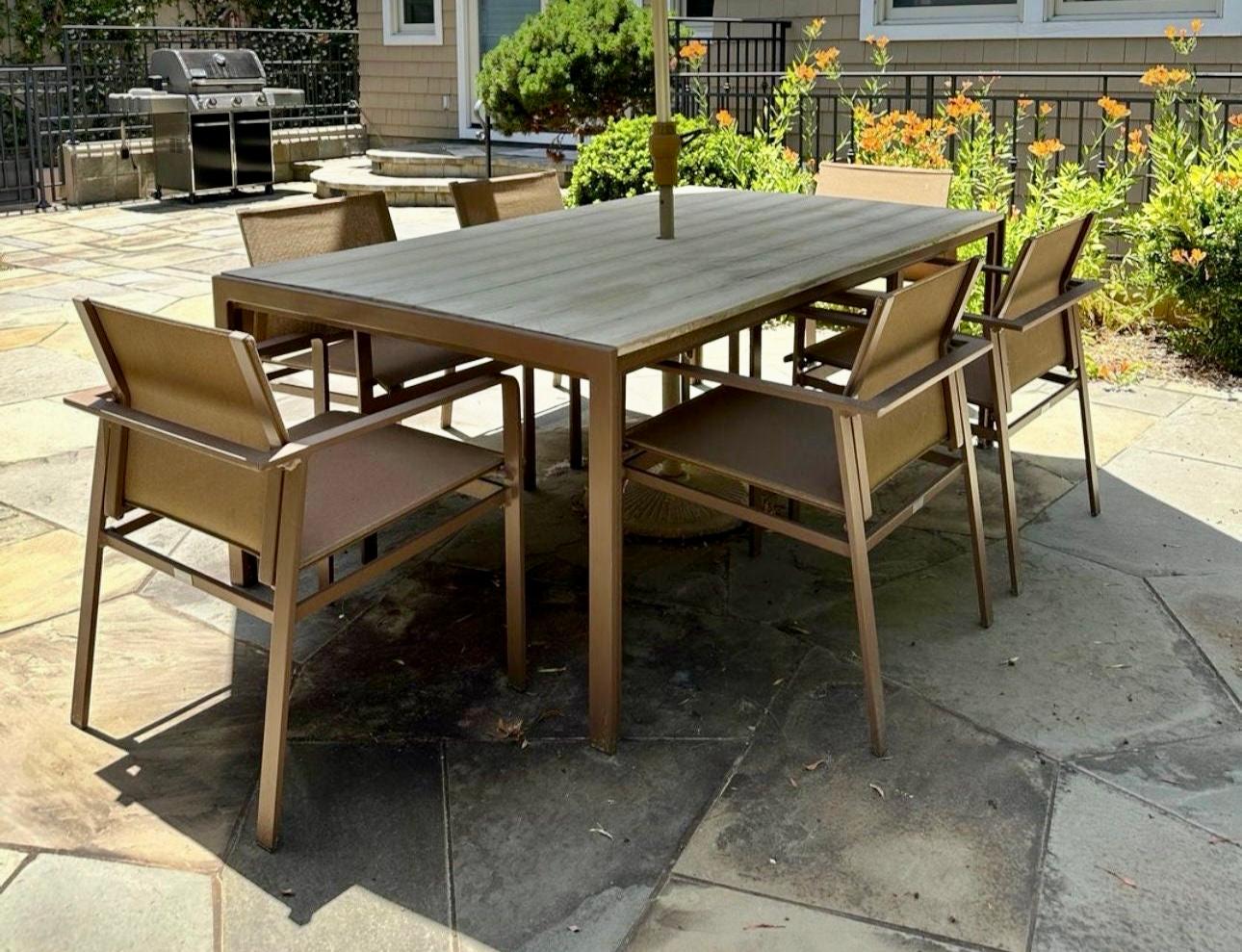 Brown Jordan classic designer set designed by Richard Frinier.
Dining Table & 6 sling armchairs designed by Richard Frinier. This timeless set seats 6 comfortably, however will fit up to 8. The table measures 45x79 made of resin wood with a Java