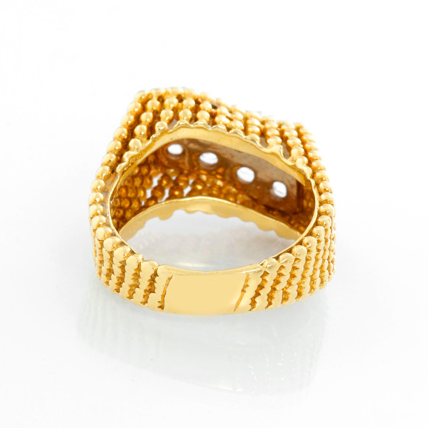 This is an 18k yellow gold ring with a beaded texture featuring 8 diamonds. The stones are VS clarity  and F color with a total of 1 carat.  It is a size 6.5 and weighs 8.3 grams. This ring features a fun wave design and is great for everyday.