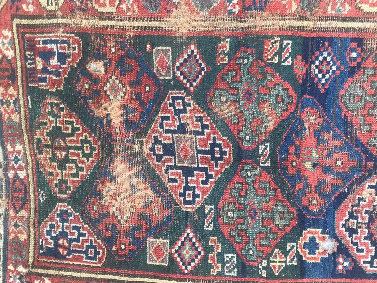 Very beautiful antique Kurdish rug with nice geometrical Caucasian design and natural blue field with green, red and antique purple colors, entirely hand knotted with wool velvet on wool foundation.