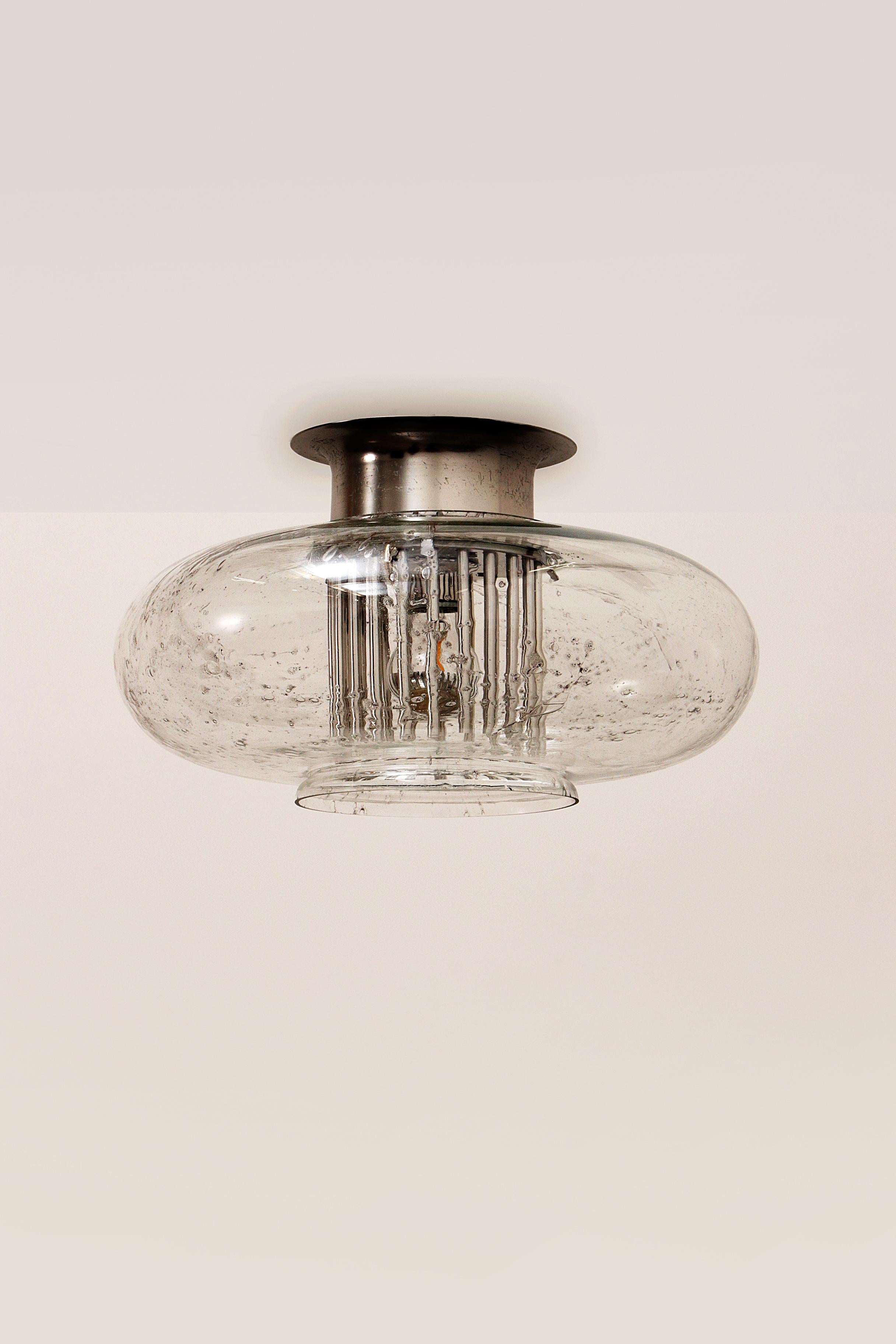 A beautiful round vintage Doria Leuchten ceiling lamp with glass shade of special speckled glass. The glass is of high quality and has a special texture that spreads the light in a beautiful way. Beautifully finished with a chrome ceiling cap and a