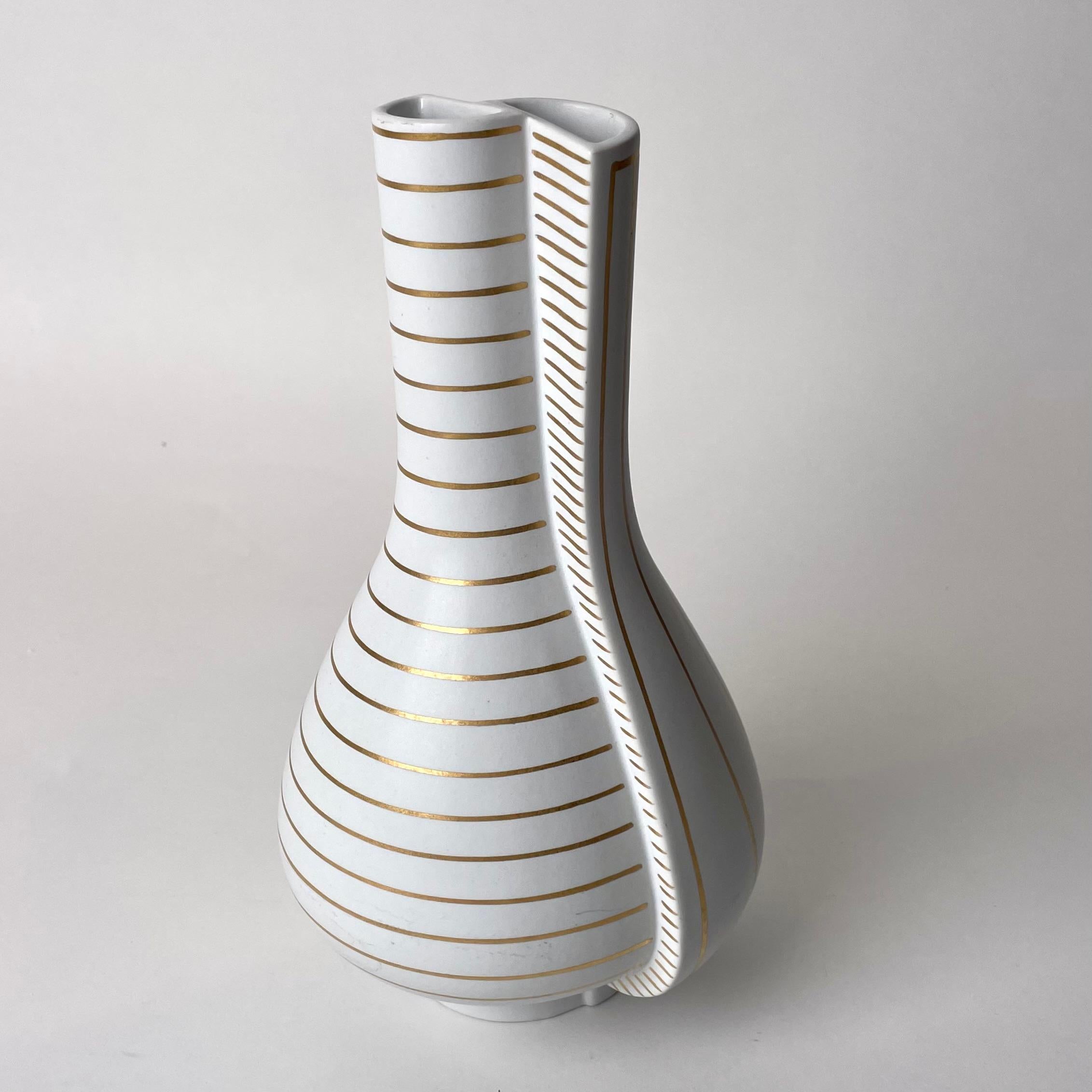 Beautiful Double Vase in Stoneware called ”Guldsurrea” and designed 1939 by Wilhelm Kåge (1889-1960). Made at Gustavsberg Studio in Sweden.

Wilhelm Kåge was artistic director at the the Gustavsberg Porcelain Factory between the years