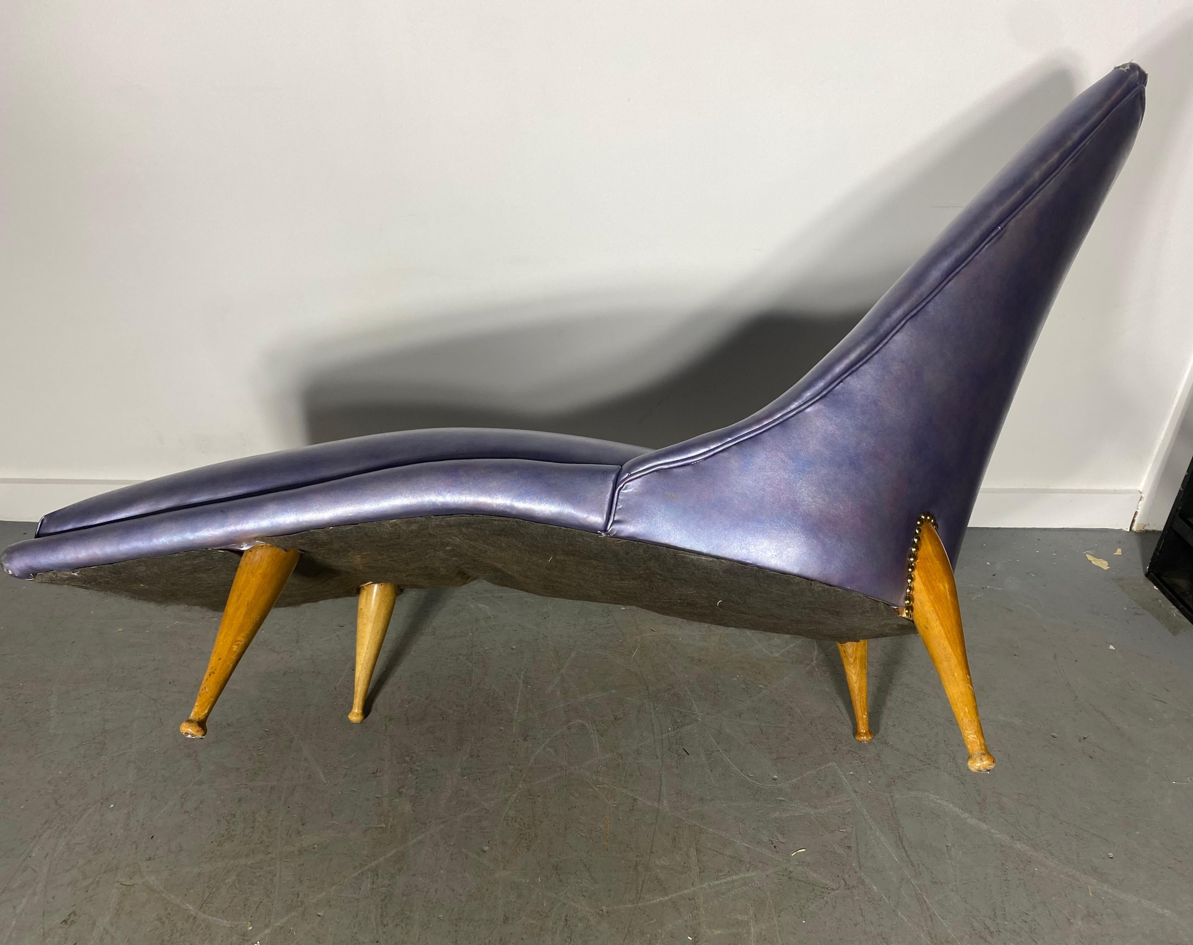 A rare ‘Beautiful Dreamer’ chaise lounge designed by Ben Seibel in the 1950s. This lounge has an elongated curved seat and a dramatically angled back stands on four tapered wooden legs with petite ball feet. USA, Lounge reupholstered at some