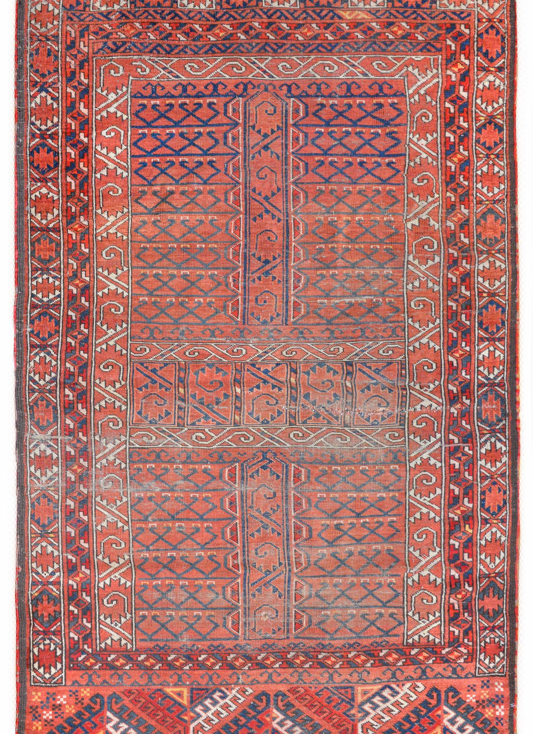 A beautiful early 20th century Ersari Turkman rug with an all-over tribal pattern containing stylized flowers and vines woven in geometric stripes across the field, and surrounded by a complex border containing multiple geometric pattered stripes