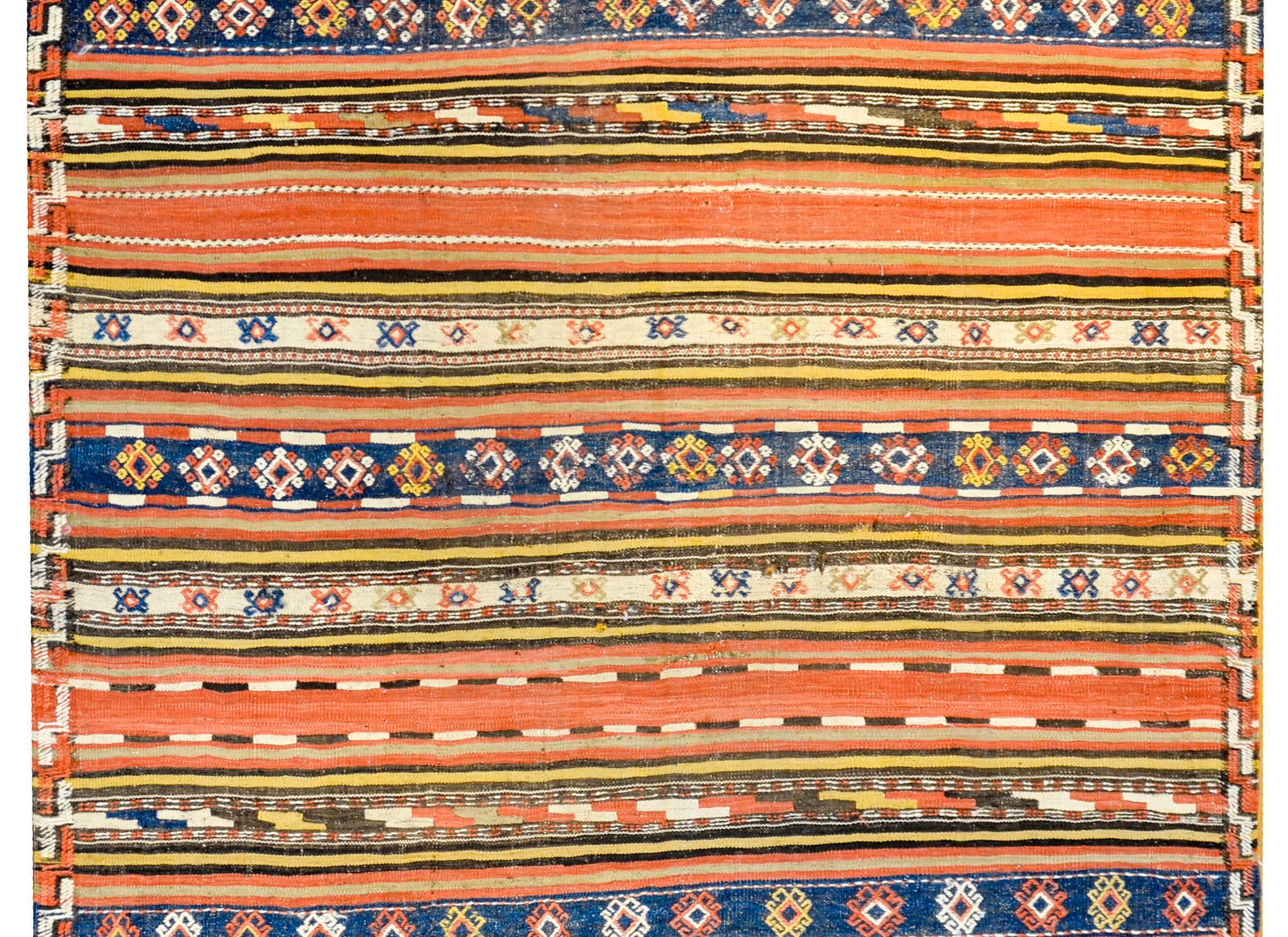 A wonderful early 20th century Persian Shahsevan Kilim rug with alternating boldly colored multicolored stripes of geometric and striped design. The border is thin with striped and zigzag pattern.