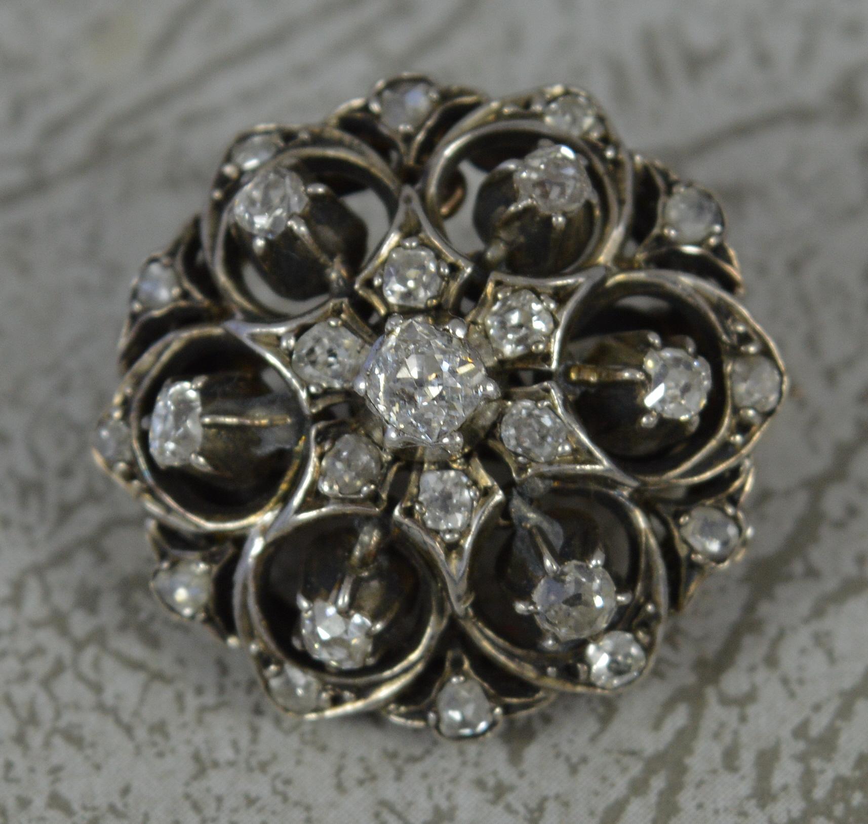 A stunning early Victorian period brooch.
Solid 15 carat rose gold example with a silver head setting.
Designed with many old mine cut diamonds set throughout. Set with over one carat of natural diamonds. Clean, bright and sparkly.
A circular shaped