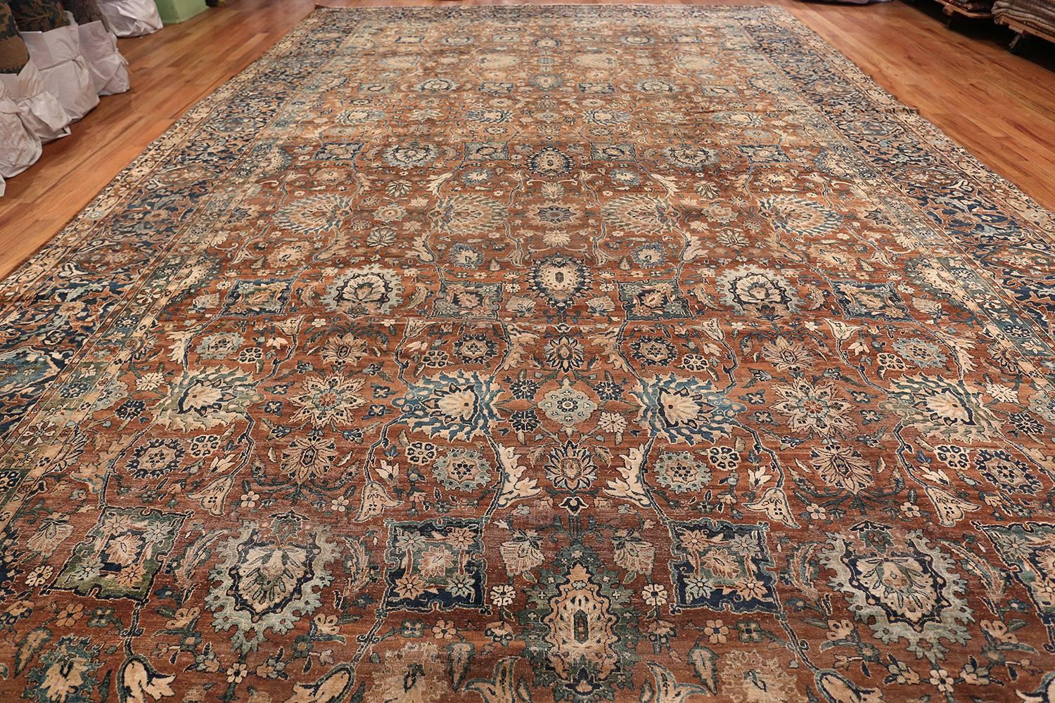 Extremely fine and decorative oversized antique Persian Kerman carpet, country of origin / rug type: Persian rug, date circa 1920. Size: 12 ft. 7 in x 24 ft. 10 in (3.84 m x 7.57 m)

The rich earthy brown background of this elegant antique Persian