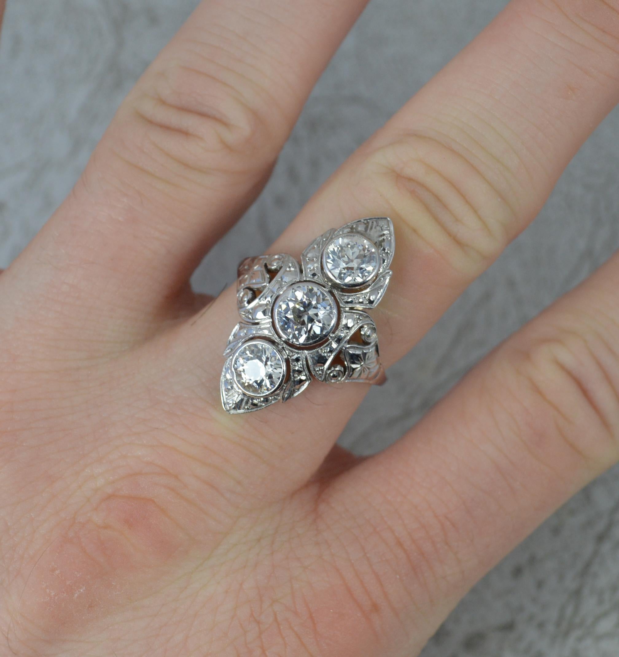A Platinum and Diamond ladies engagement ring from circa 1910/20.
Set with three natural old European cut diamonds in full bezel settings. Total weight approx 2.10 carats. Vs clarity. Bright, white and sparkly.
Designed as a navette or panel shaped