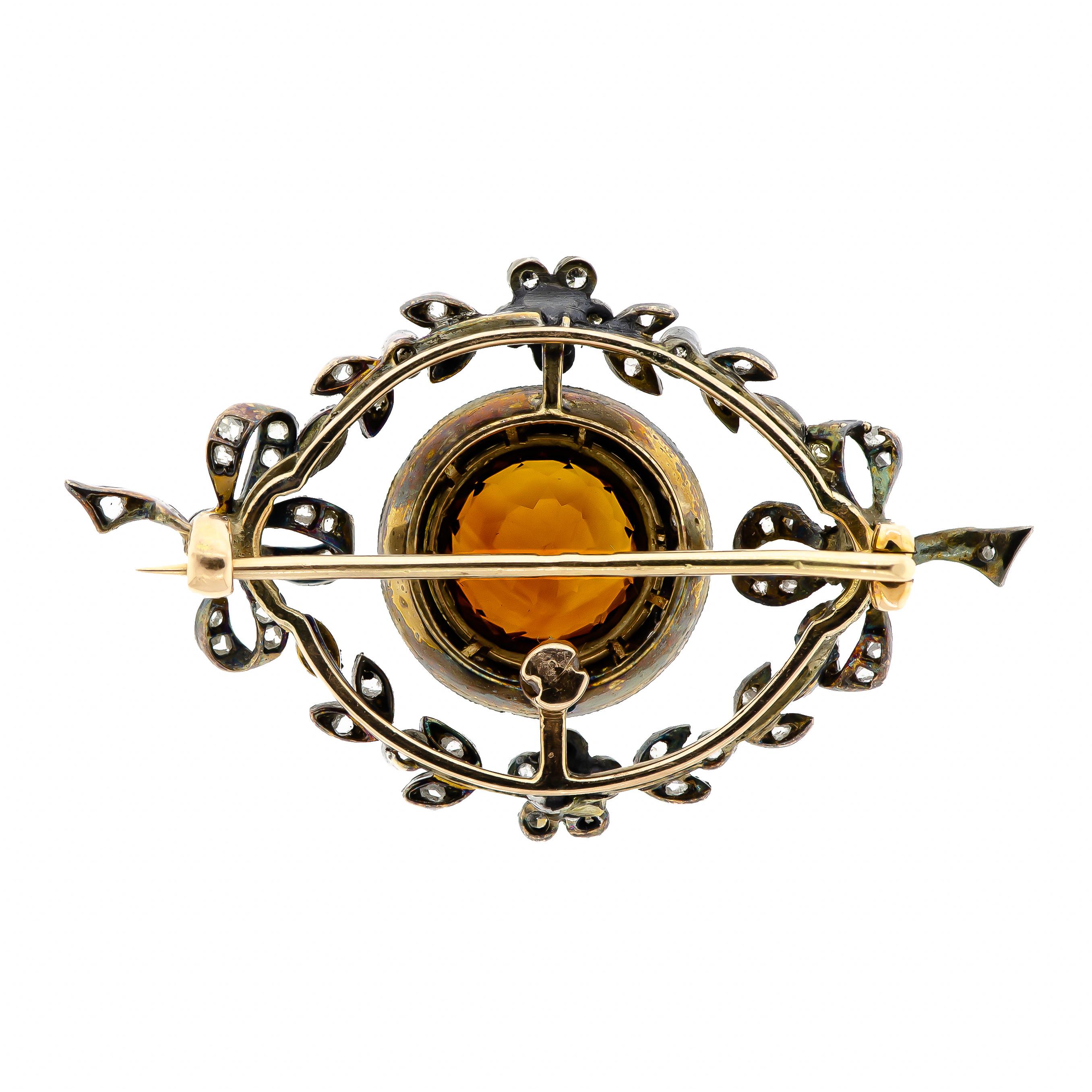Beautiful Edwardian citrine and diamond brooch bow and foliate motif central set brilliant cut round citrine surrounded by a circle of rose cut diamonds further embellished with rose cut and old cut diamonds in bow foliate motif silver topped yellow
