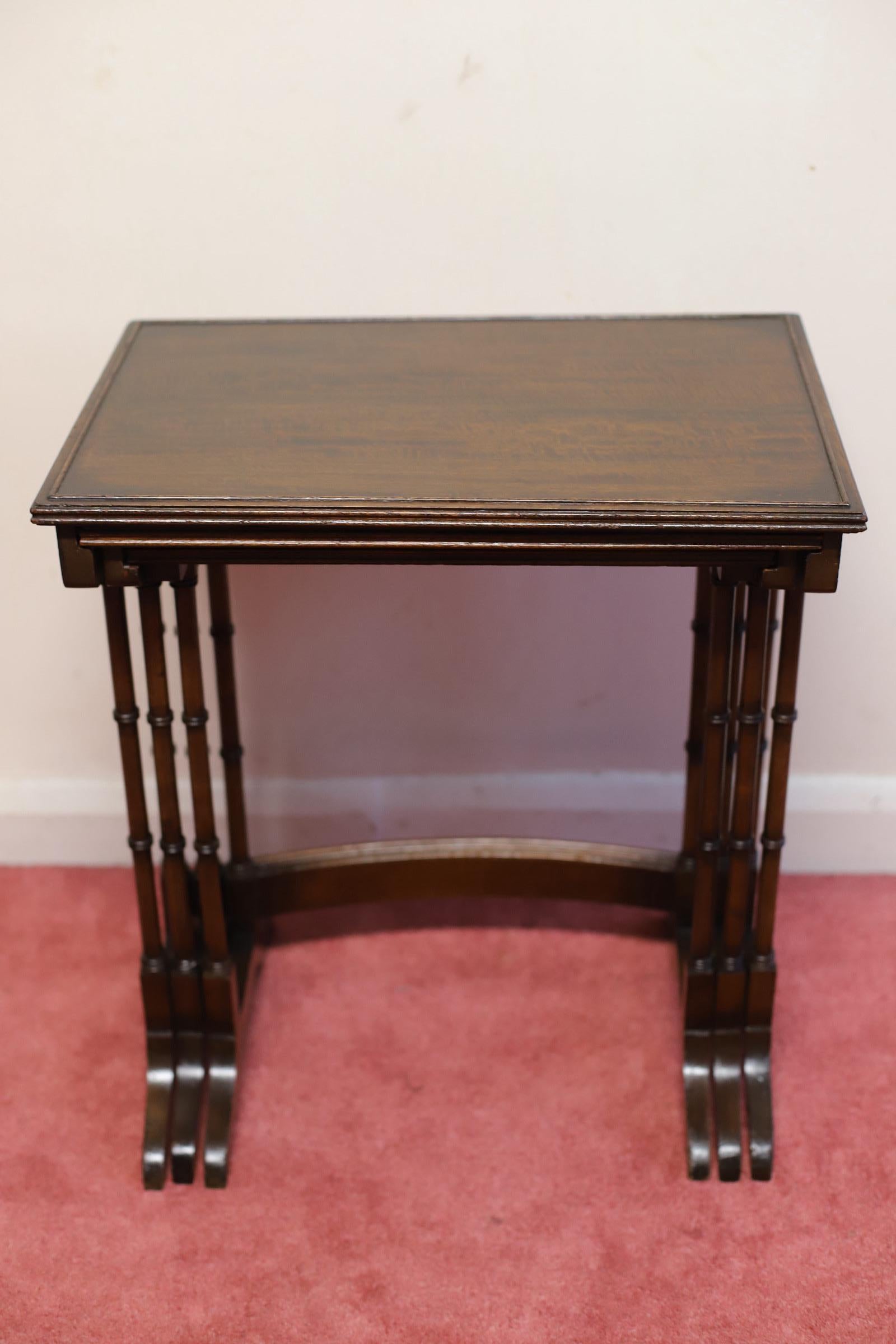 We delight to offer this lovely set of three table , each table has the rectangular solid mahogany top with the raised ebony bead to help stop items sliding off.
Each table stands on a pair of ring turned supports to each side joined by a curved