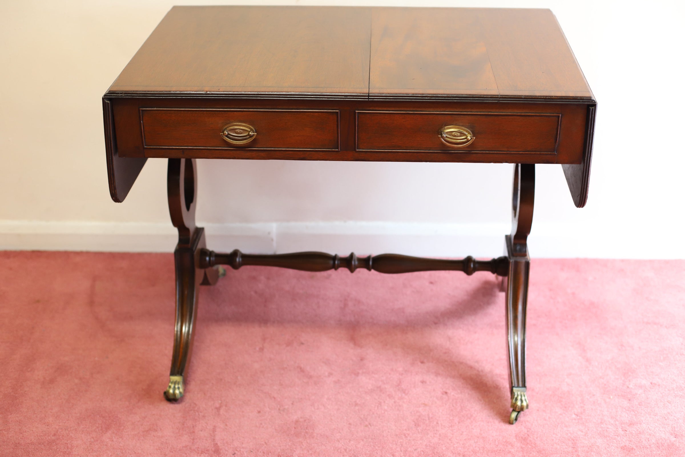 Beautifull Edwardian oak Sofa Table is in Great Condition having a Cross banded Inlay and Readed Edged Top and Two Extending ends supported by Two Solid Swing Out Stays Underneath. Below the Top the Table has two Drawers to one Side and Two dummy