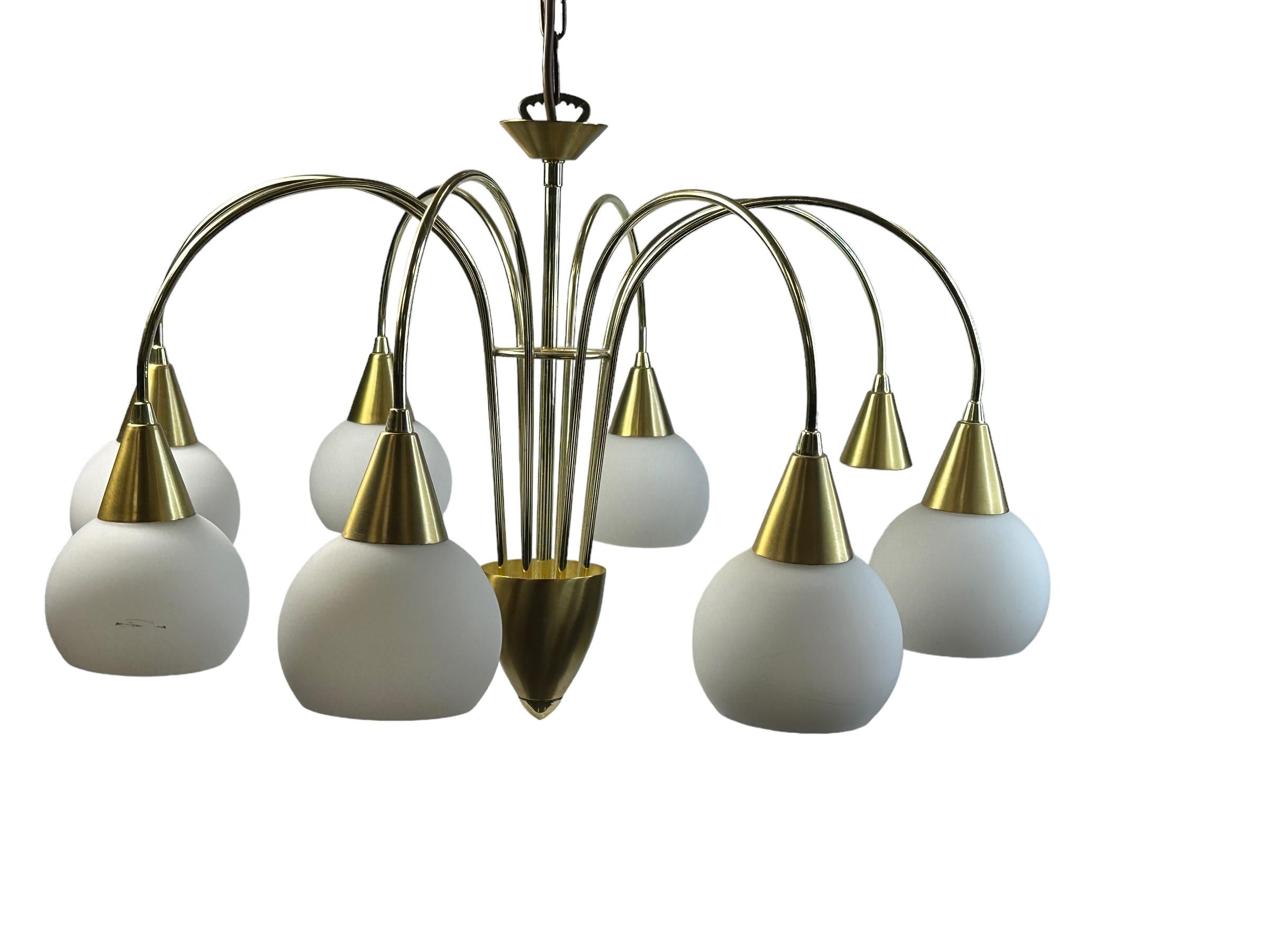 Delicate eight-light brass chandelier with glass ball shades. Works as intended with eight E14 / 110 volt light bulbs. Can hold up to 40 watts per bulb. Beautiful brushed metal chandelier with white glass shades. It provides a very warm light and