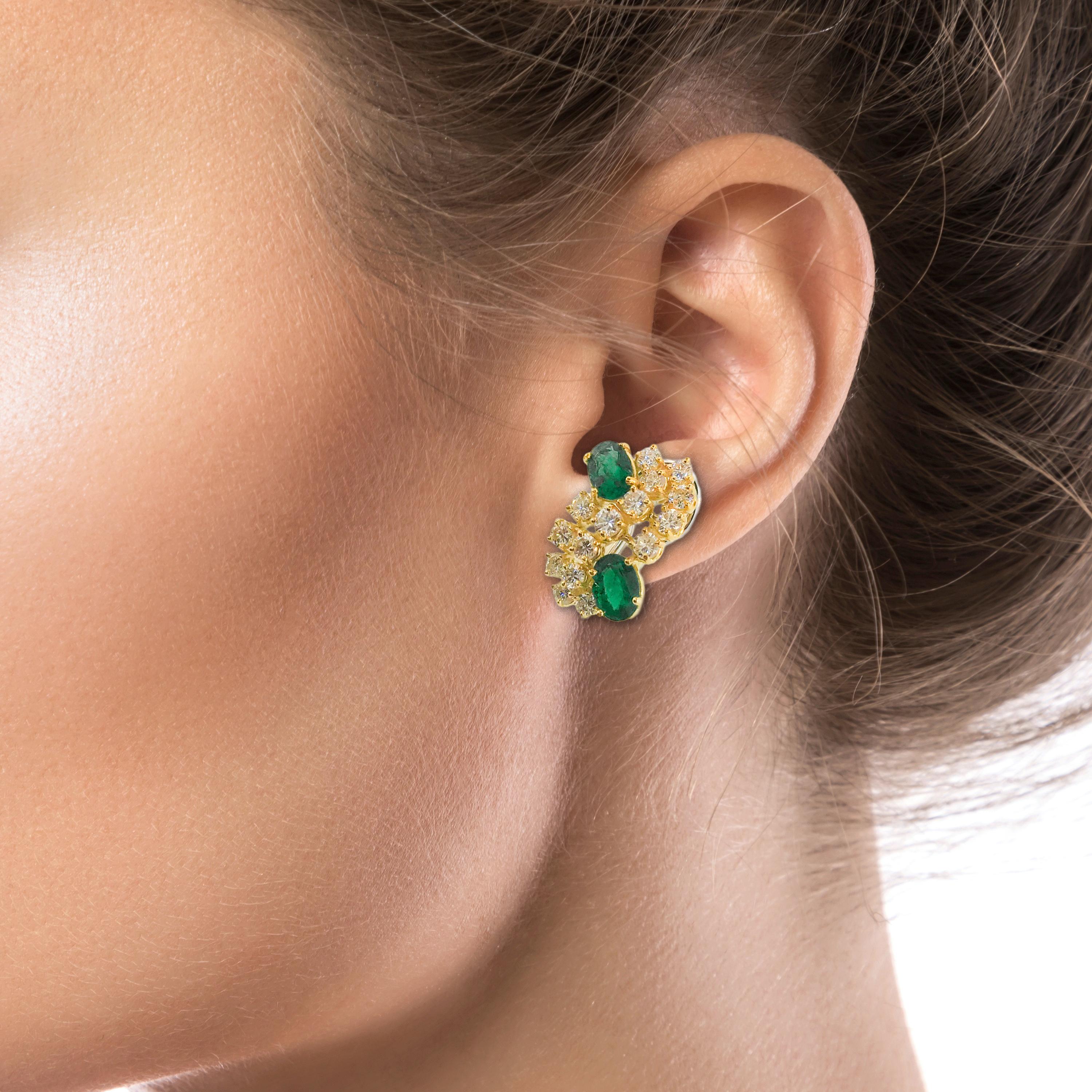 The 18K Yellow Gold Emerald and Diamond Earrings are of a cluster 