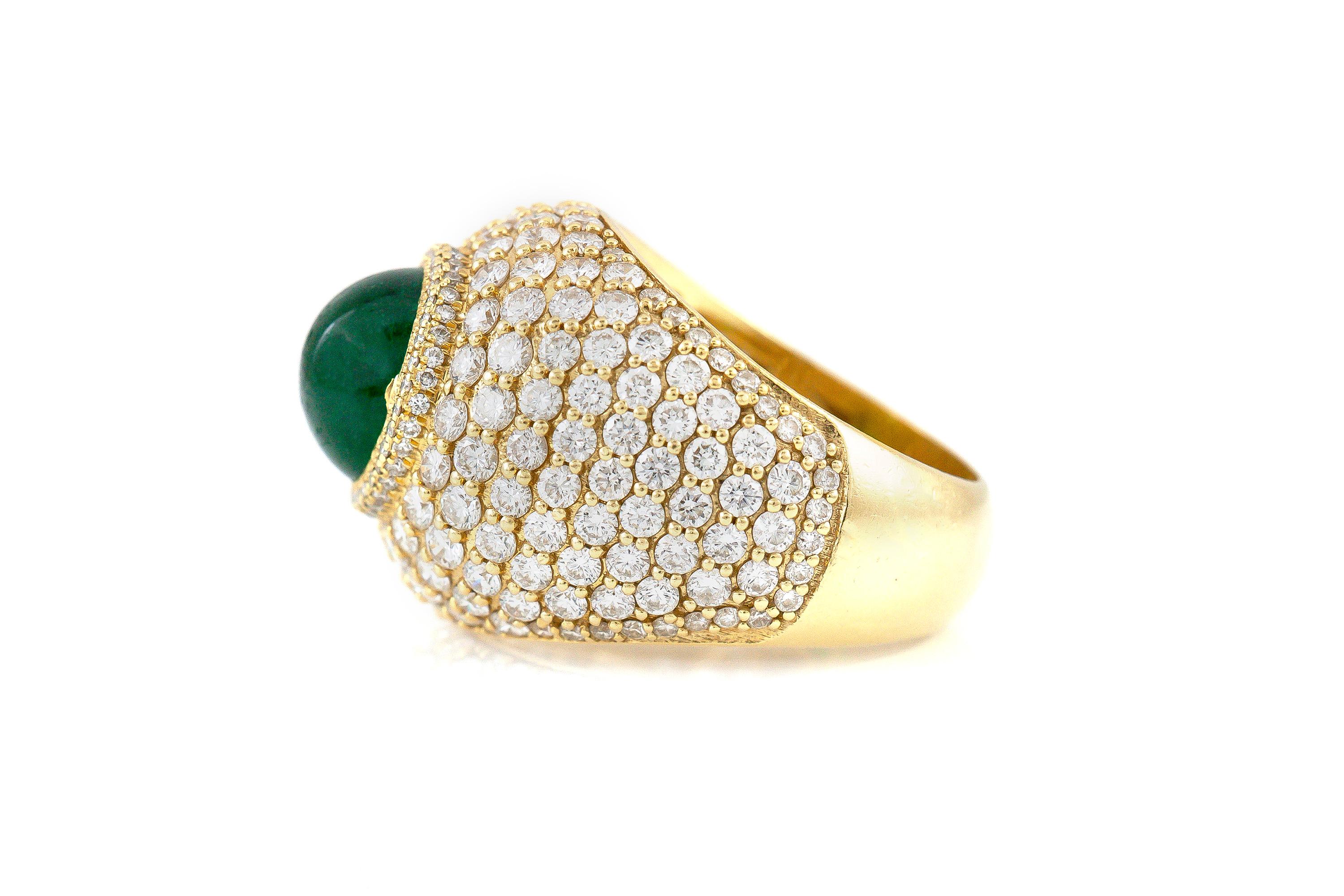 Finely crafted in 18K gold featuring a center cabochon emerald weighing approximately 3.00 carats surrounded by Round-Brilliant cut diamonds weighing a total of approximately 8.00 carats.
Circa 1970.