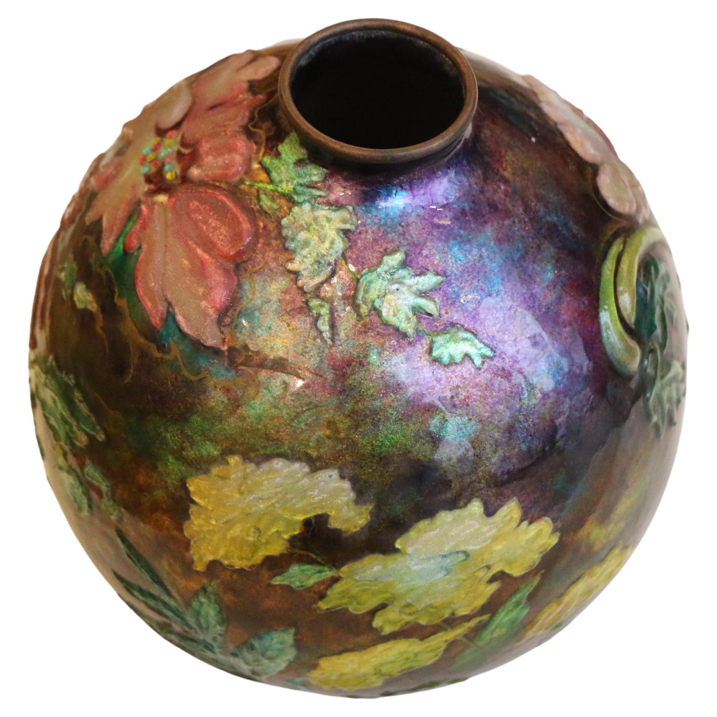 Beautiful spherical vase by Camille Fauré (model named Yvonne). It is made of copper and enamelled with floral (poppies) design. The enamel is superb in its delicacy, sophistication and variety of colors. 

Camille Fauré relaunched the multi