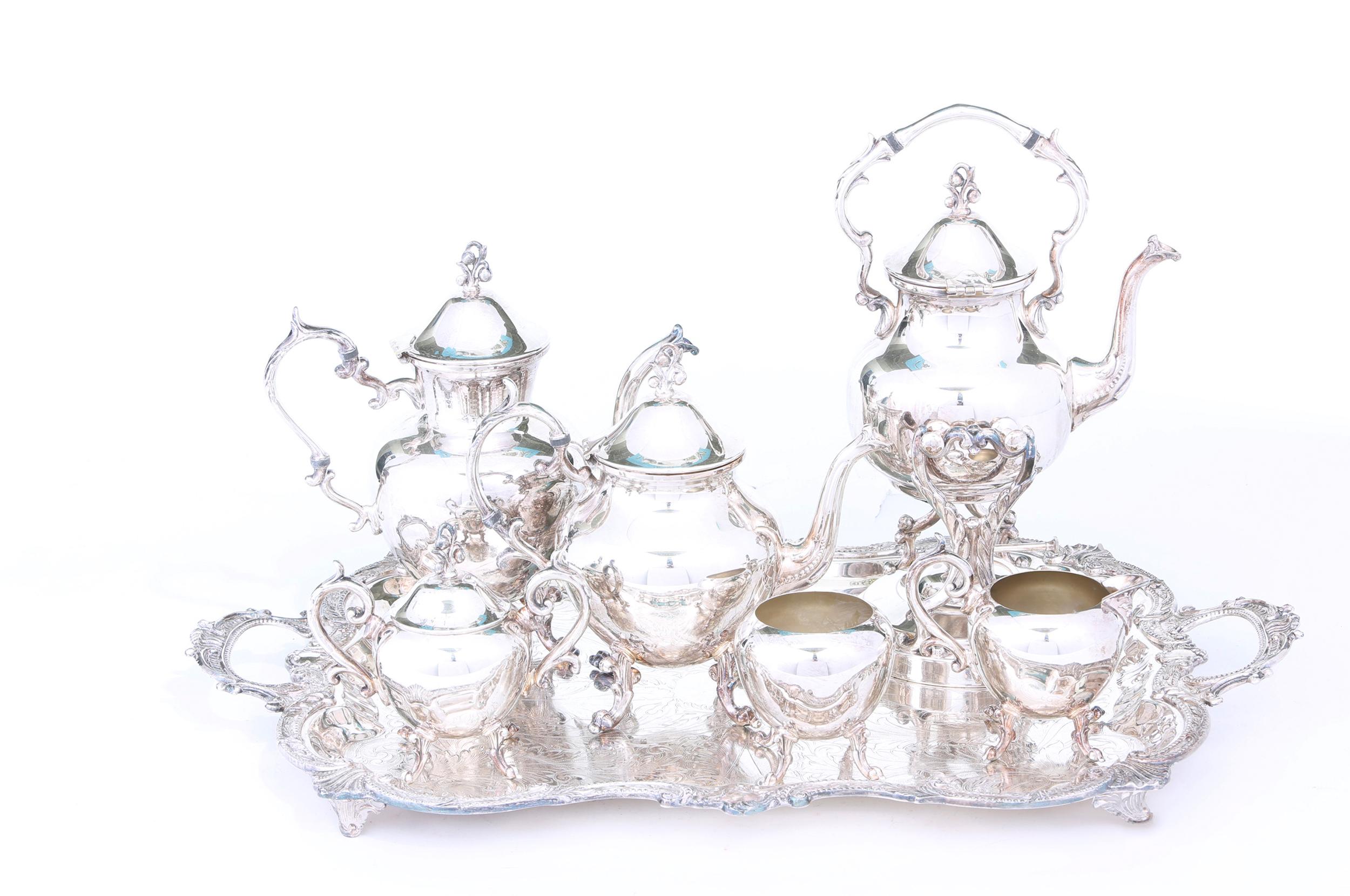 Beautiful English silver plated seven-piece tea or coffee service with exterior design details. Maker's mark undersigned. The tea or coffee service is in great vintage condition. Measures: Coffee pot is 12