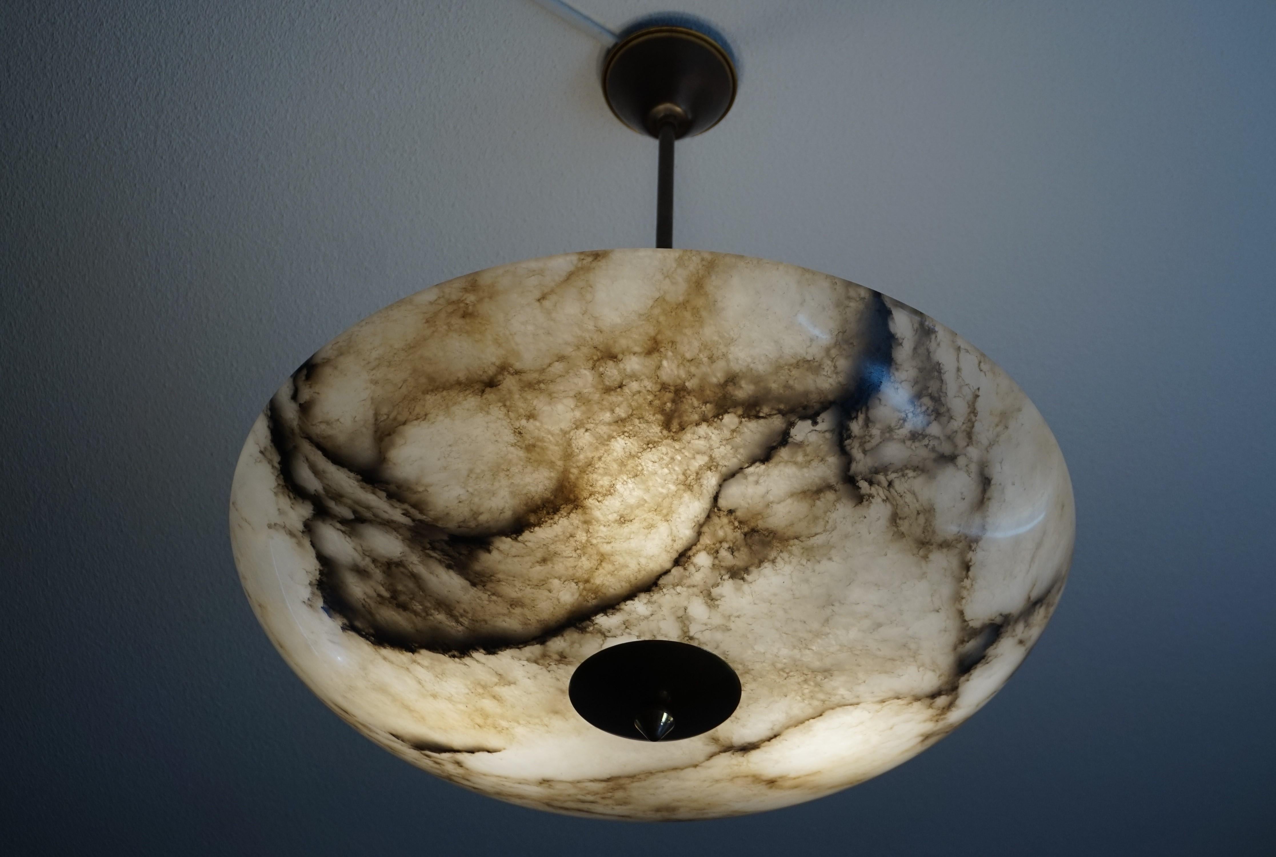 Great shape and excellent condition Art Deco ceiling lamp.

This wonderfully designed and truly beautiful light fixture has been very well looked after by its former owners. In diameter, this is the largest antique alabaster shade that we ever had