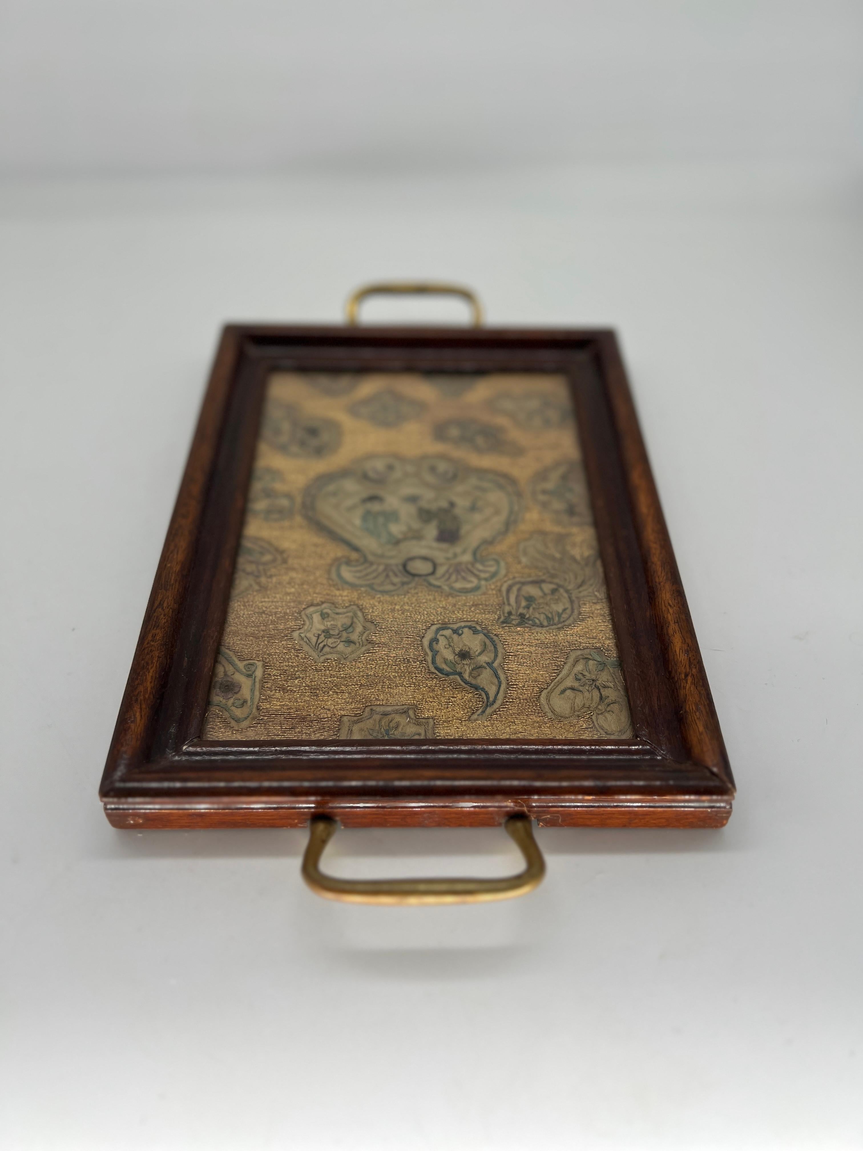 This exquisite Georgian-era tray features a stunning panel of intricate Chinese gold thread embroidery, creating a luxurious and captivating centerpiece. The rich, finely woven embroidery showcases elaborate Chinese precious object and significant