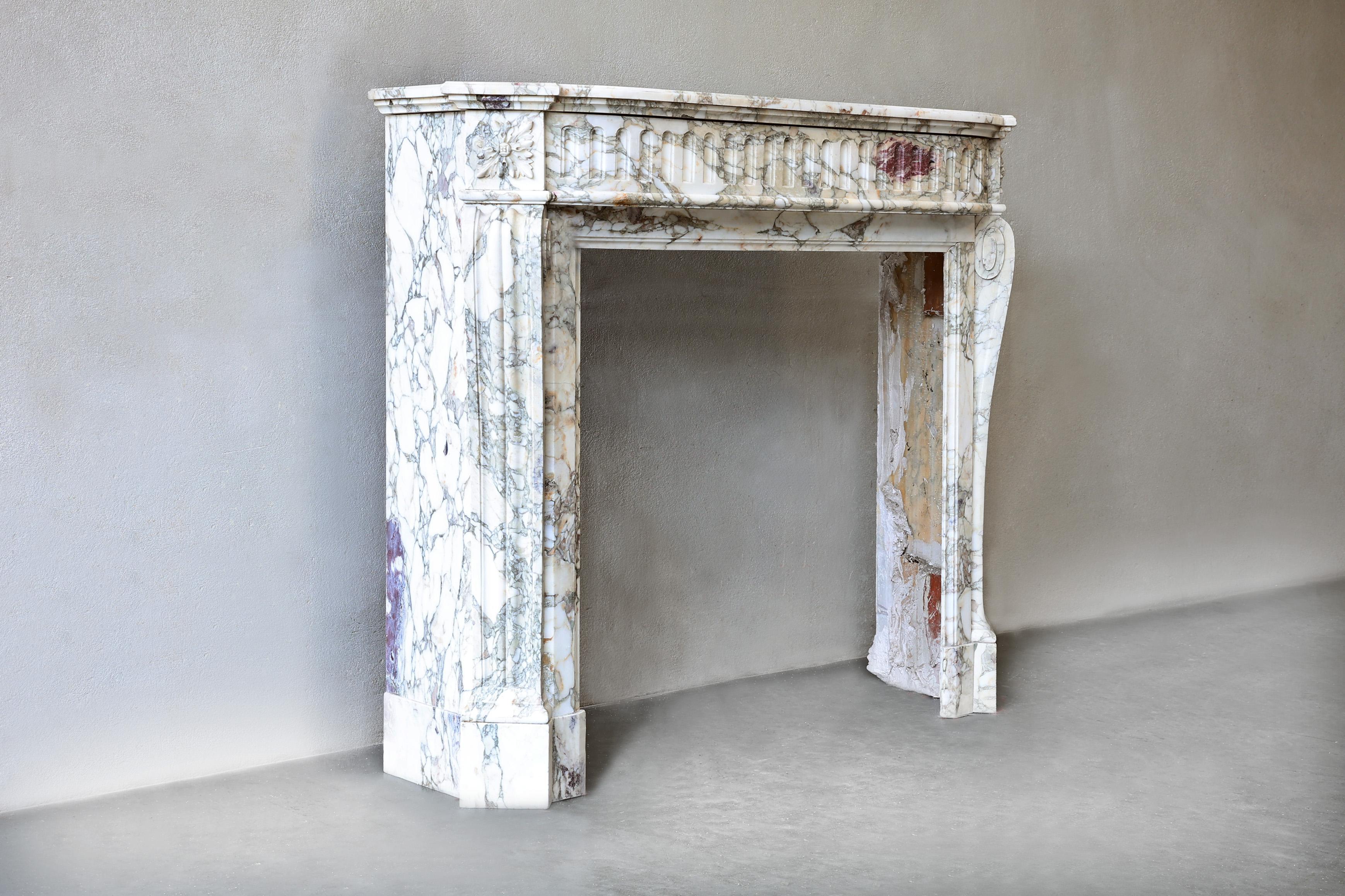 Beautiful antique fireplace of the special type of marble Calacatta Viola. This type of marble has a neutral color with a warm color nuance of violet tones! This fireplace is in the style of Louis XVI and dates from the 19th century. The mantle is